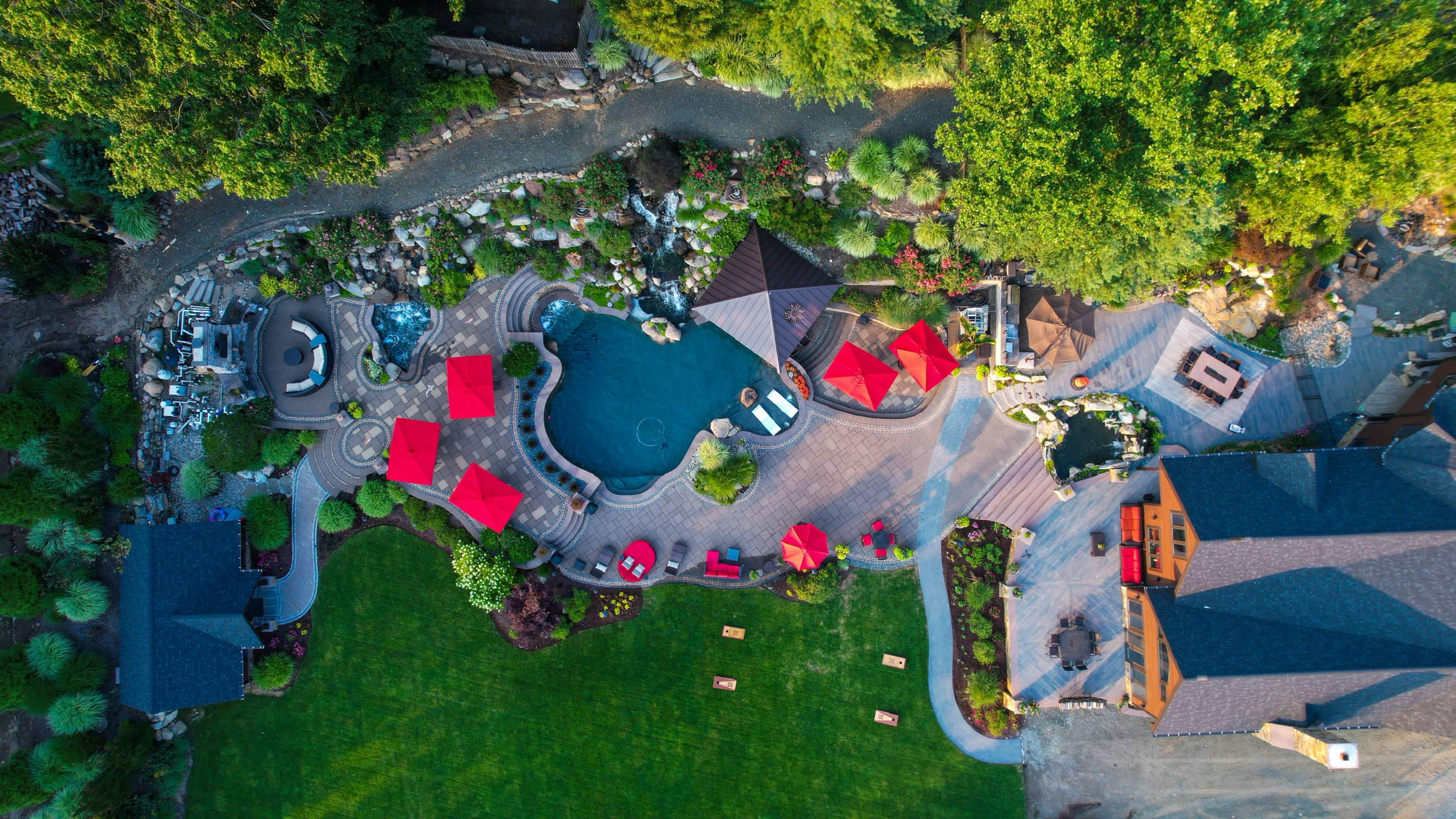 Luxury Resort-Style Backyard Oasis with Pool, Spa, Fire features, Koi pond, Outdoor Dining & entertaining Image in Pompton Plains, Wayne, NJ