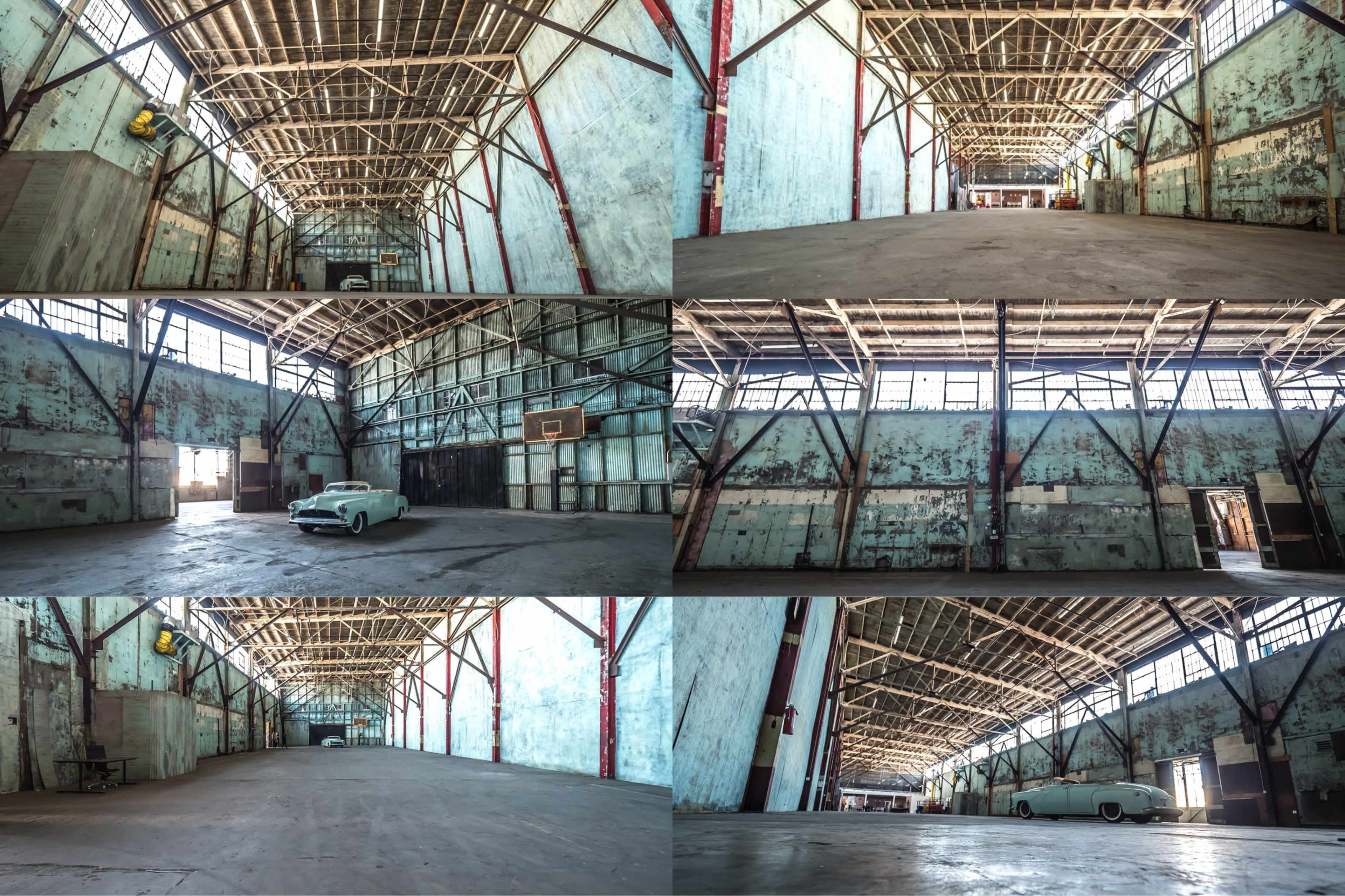 The image features a large, empty warehouse with high ceilings, exposed wooden beams, and a vintage car parked on the floor.