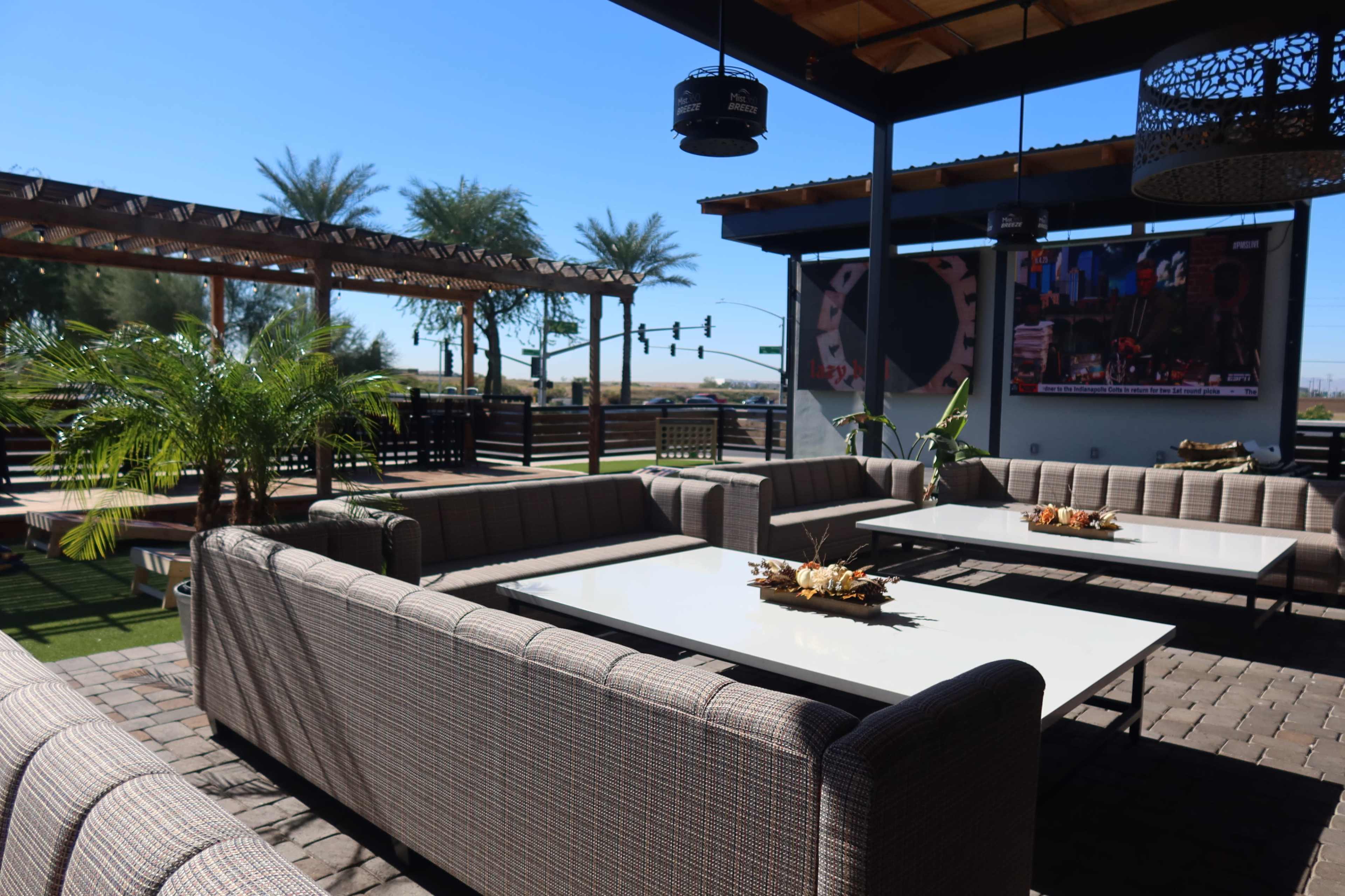 Modern Outdoor Lounge with Couches and Lush Plants Image in Park West, Peoria, AZ