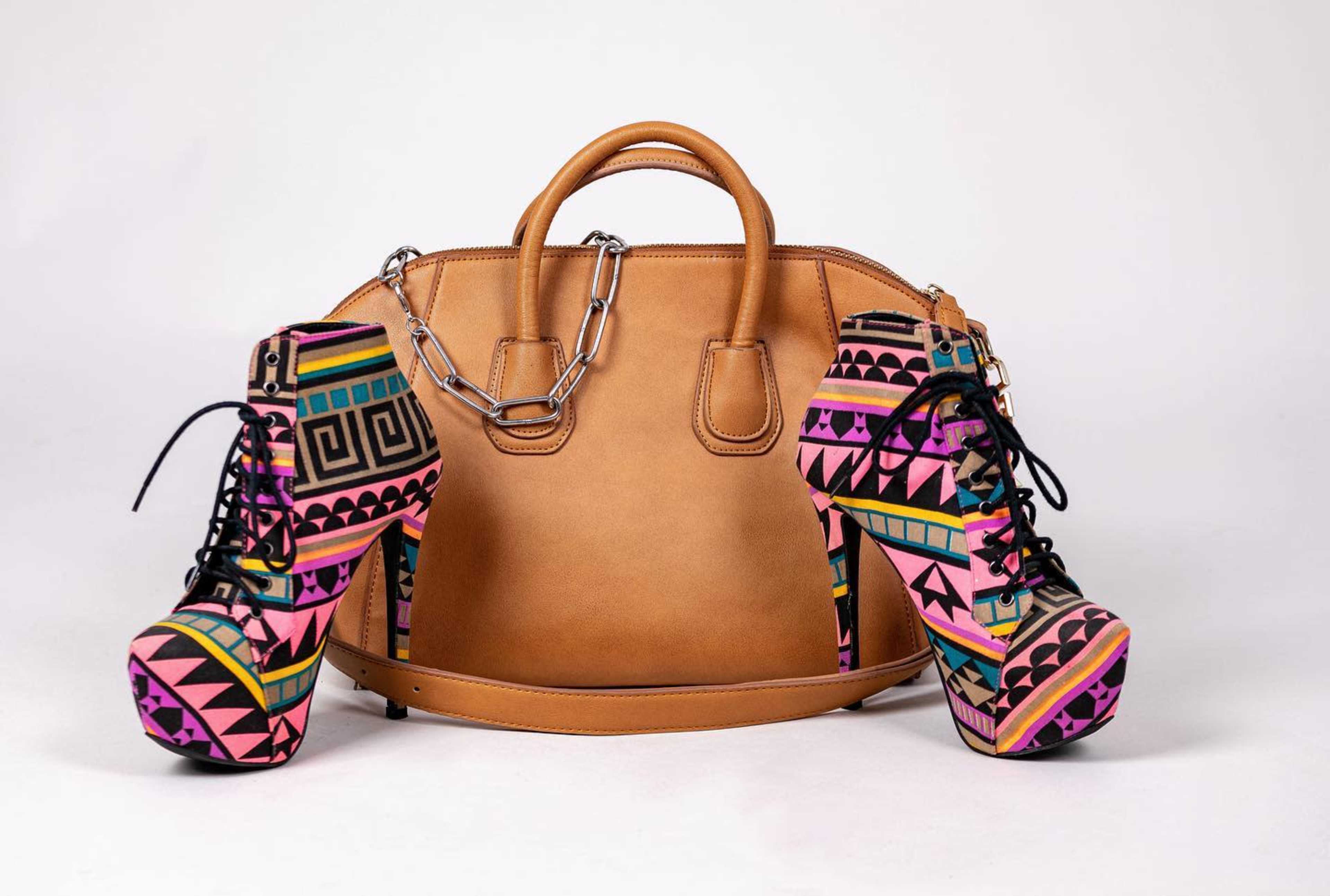 A pair of brightly patterned high-heeled shoes alongside a tan leather handbag.
