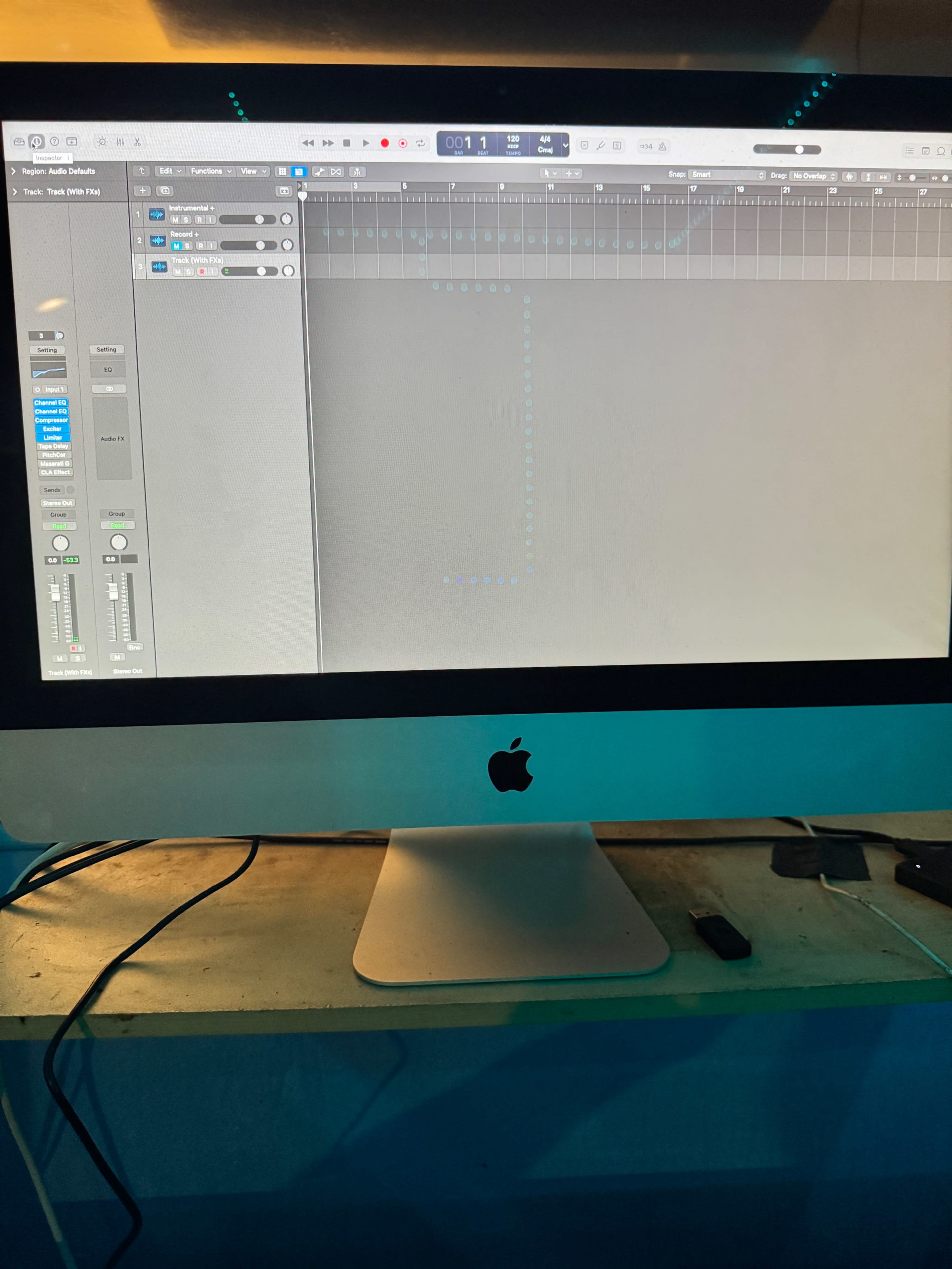 A computer screen displaying a digital audio workstation with a blank project and visible audio tracks.
