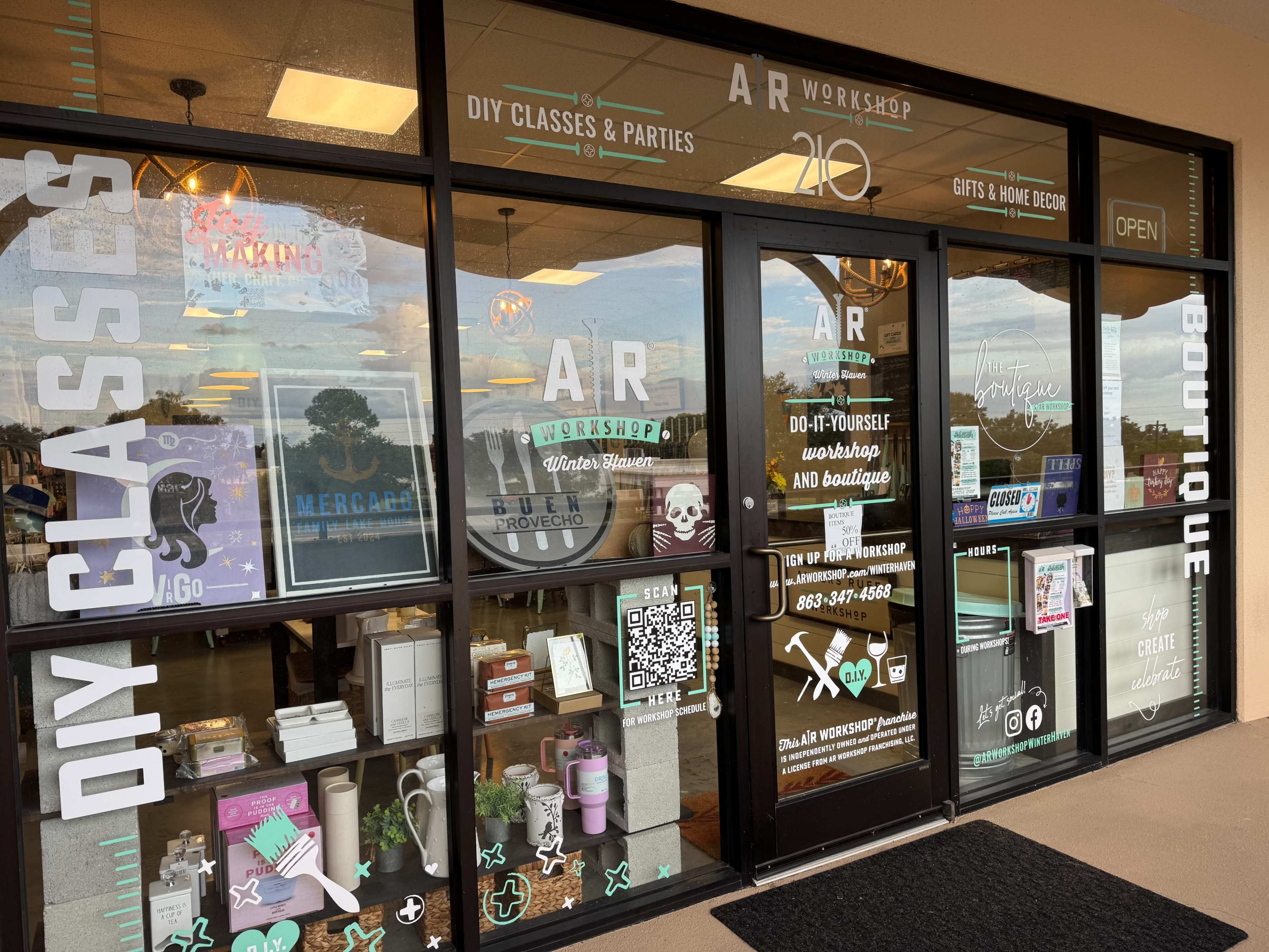 The storefront features glass doors displaying signs for DIY classes and a boutique, along with various merchandise and decorations.