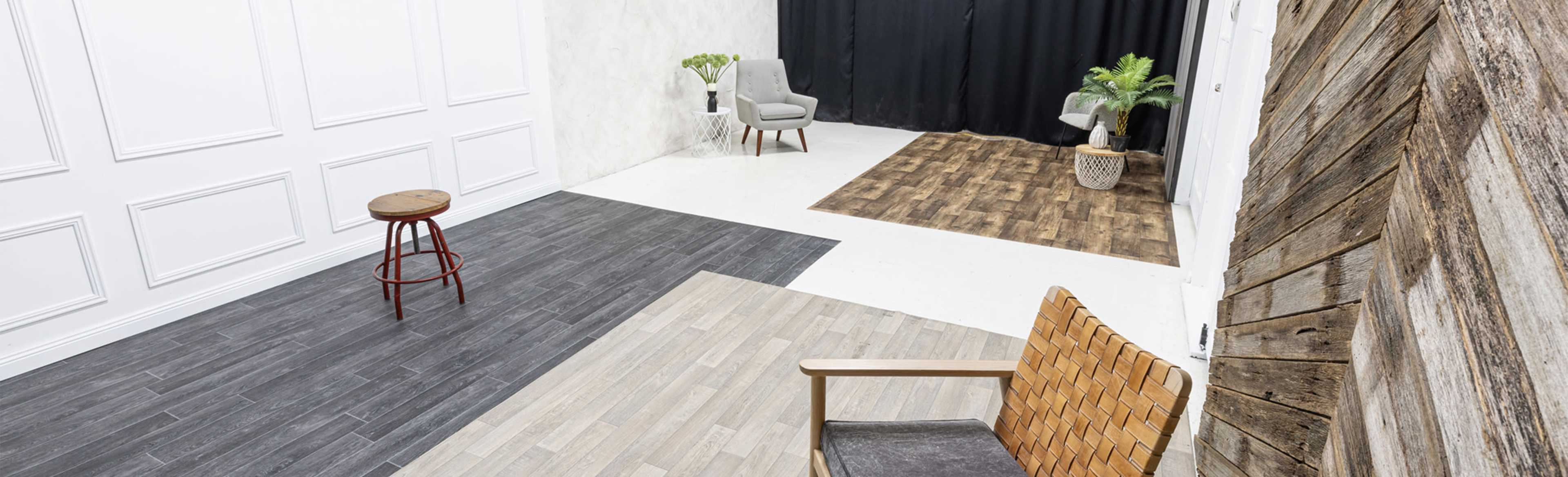 The image shows a photography studio with various flooring designs, including wood and tile patterns, alongside minimalist furniture and a black backdrop.