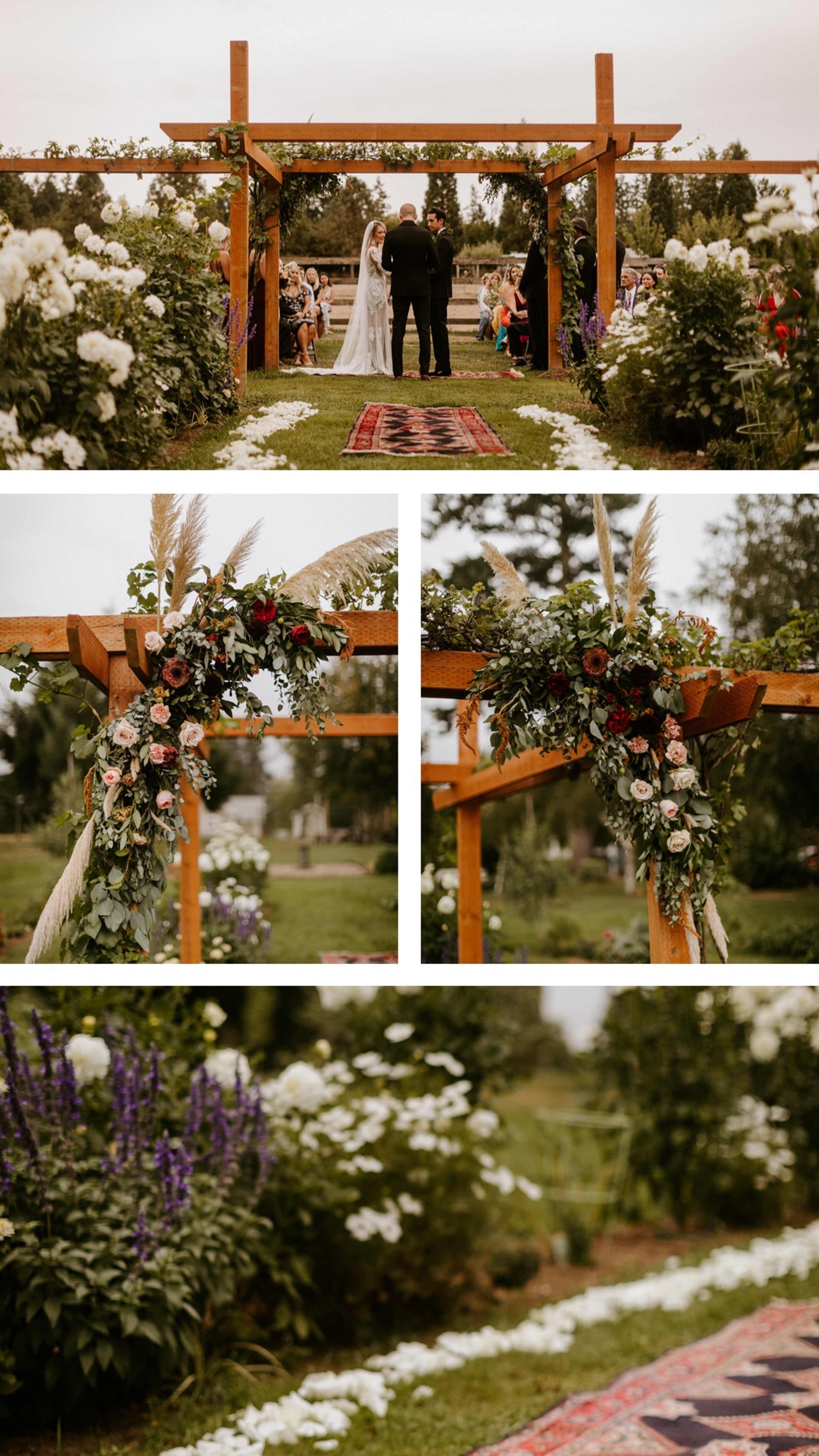 A wedding ceremony takes place under a decorated wooden arbor surrounded by greenery and floral arrangements.