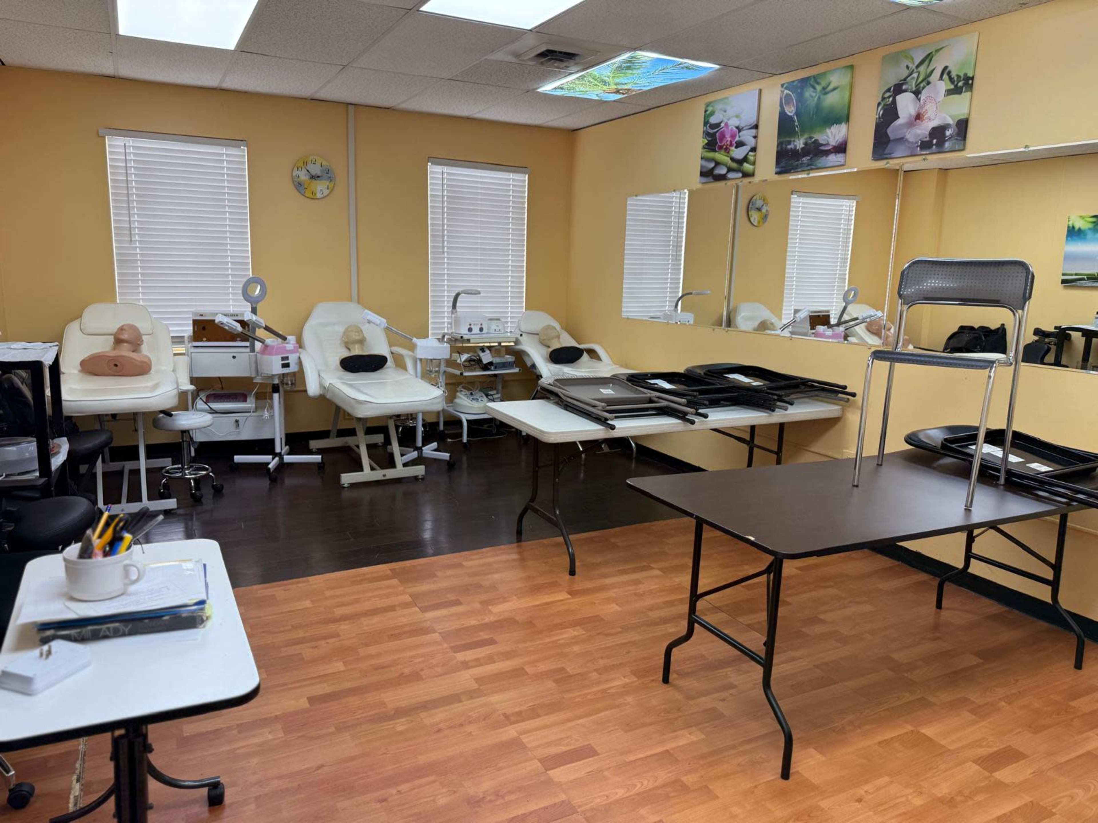 The image shows a salon or spa room with multiple treatment stations, mirrors, and tables set up for beauty services.