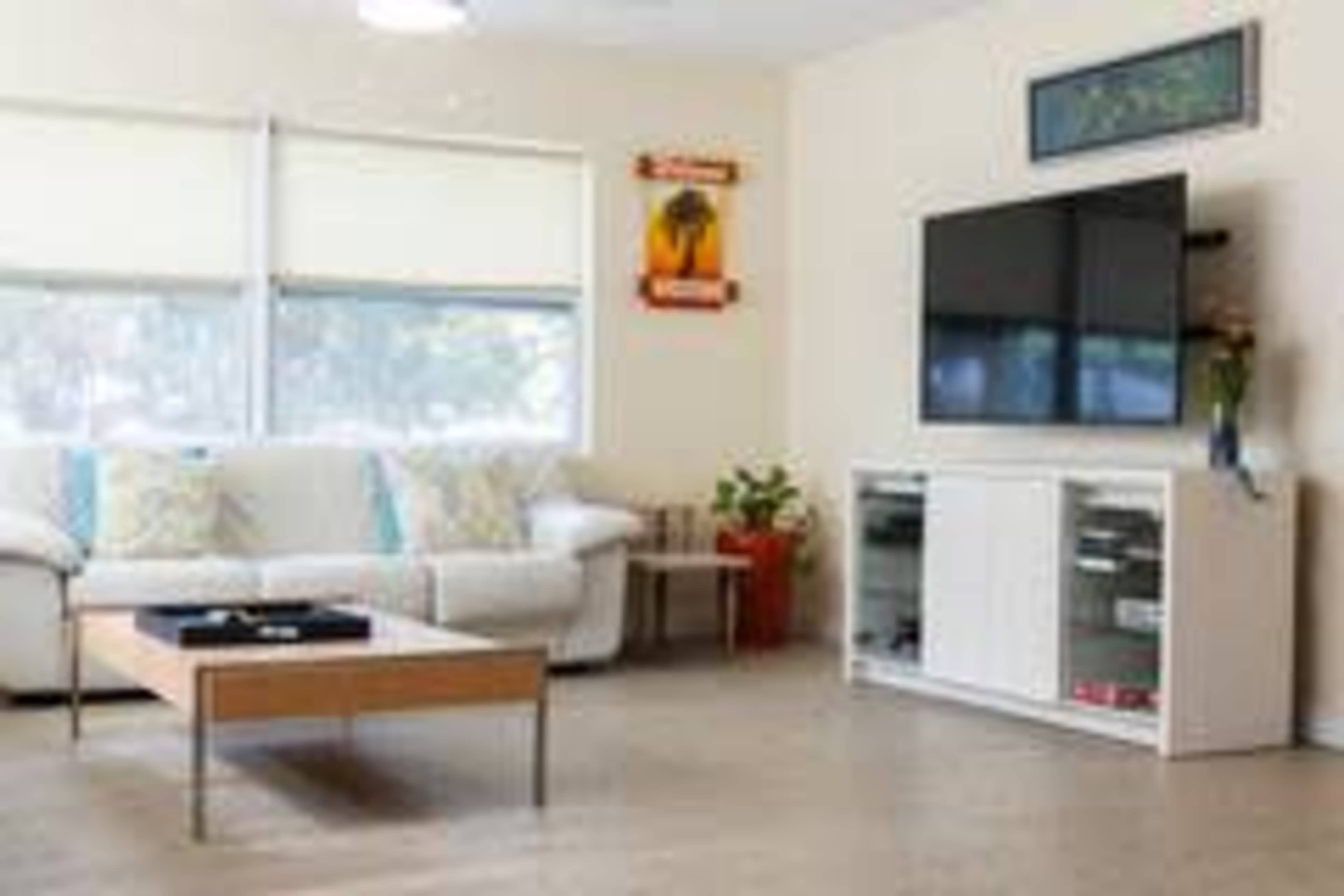 Cheerful downtown home flanked by empty green spaces Image in Gillespie Park, Sarasota, FL