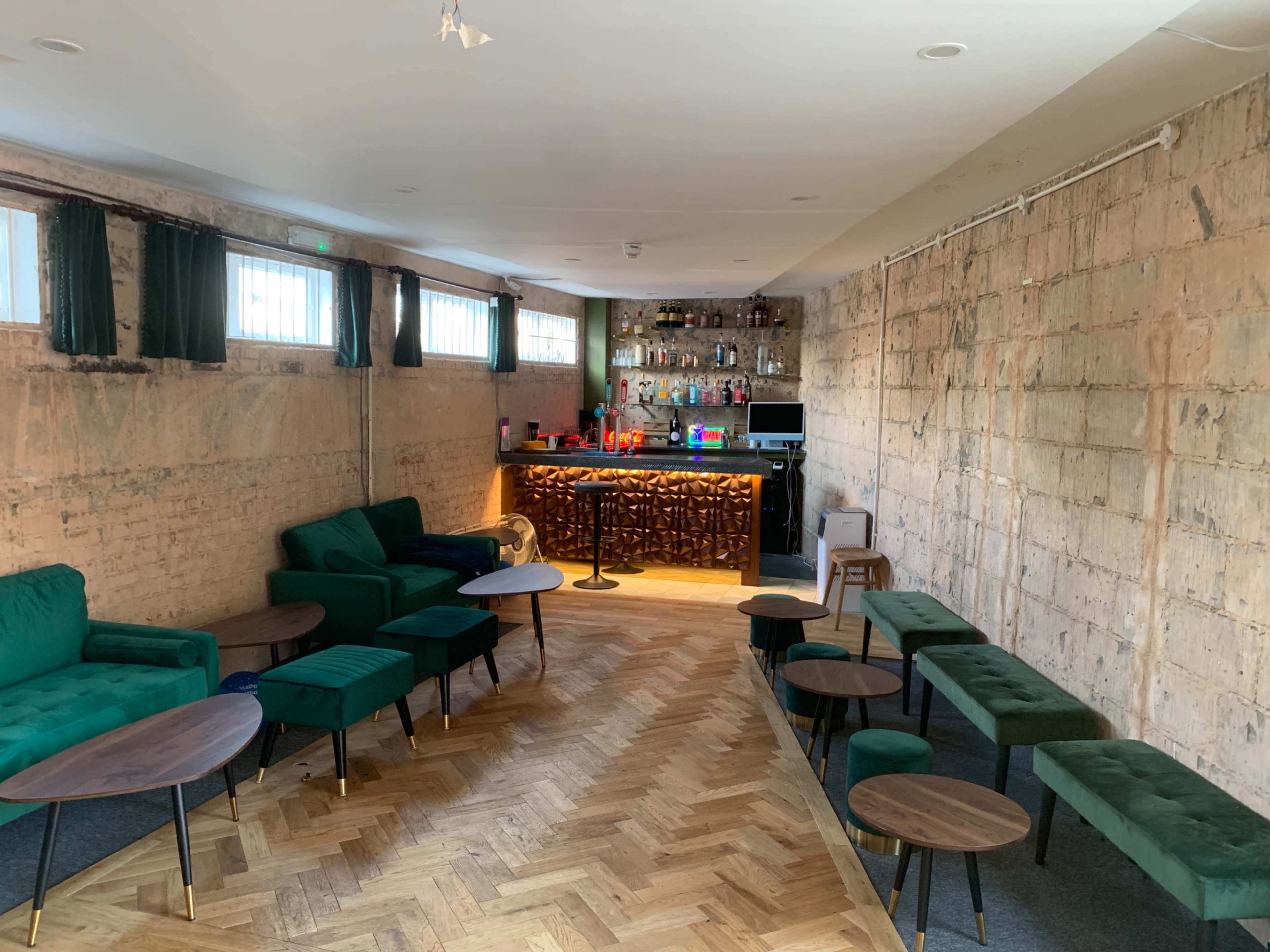 A cool urban first floor cocktail bar and restaurant lounge in a brutalist ex post office building with views over an international street food market Image in Balham, London, ENG