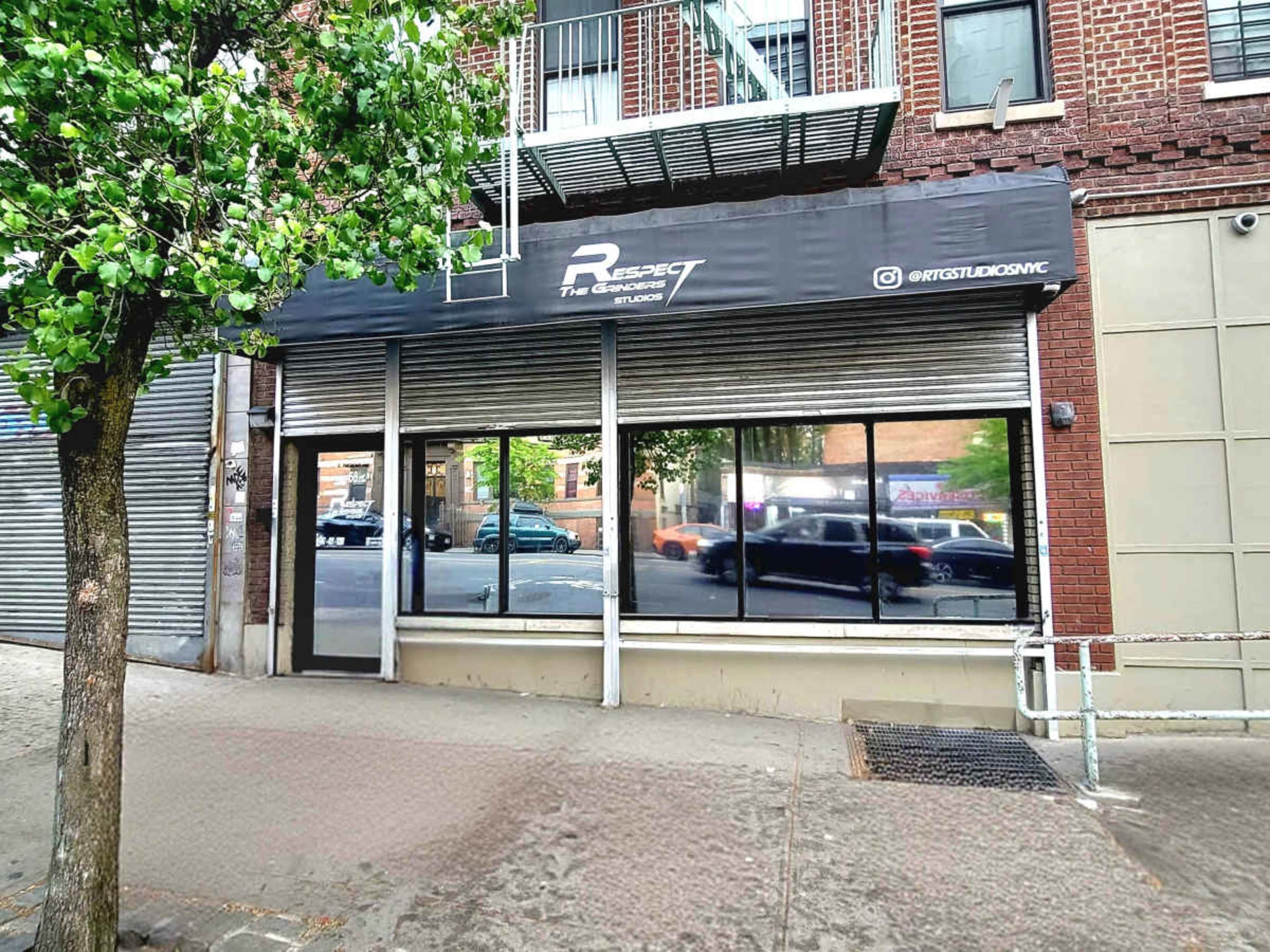 The image shows the exterior of a business called "Respect The Brand Studio," featuring large reflective windows and a covered entrance.