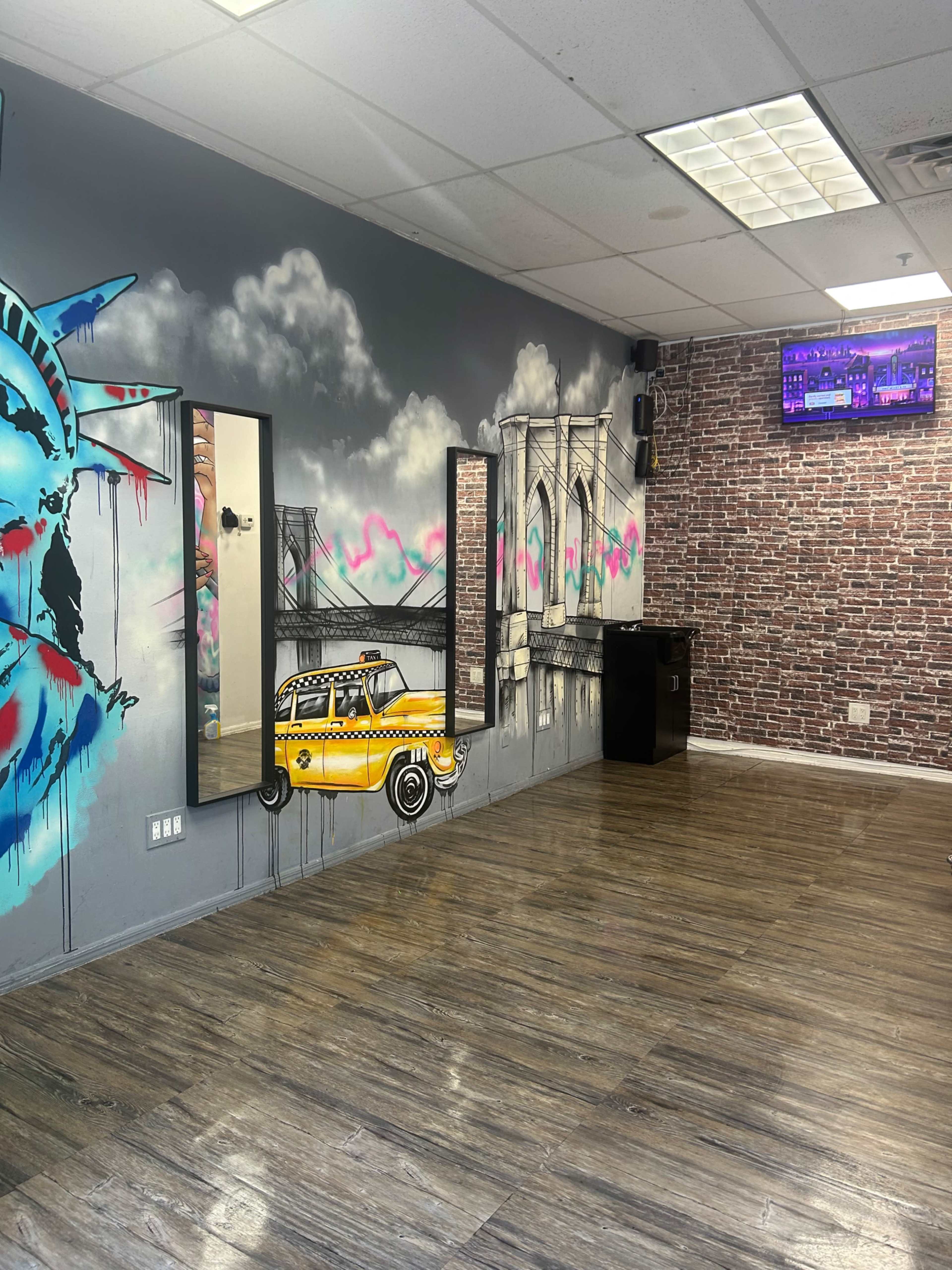 The image shows a room with urban-themed murals, including the Statue of Liberty and a yellow taxi, along with mirrored walls and wooden flooring.