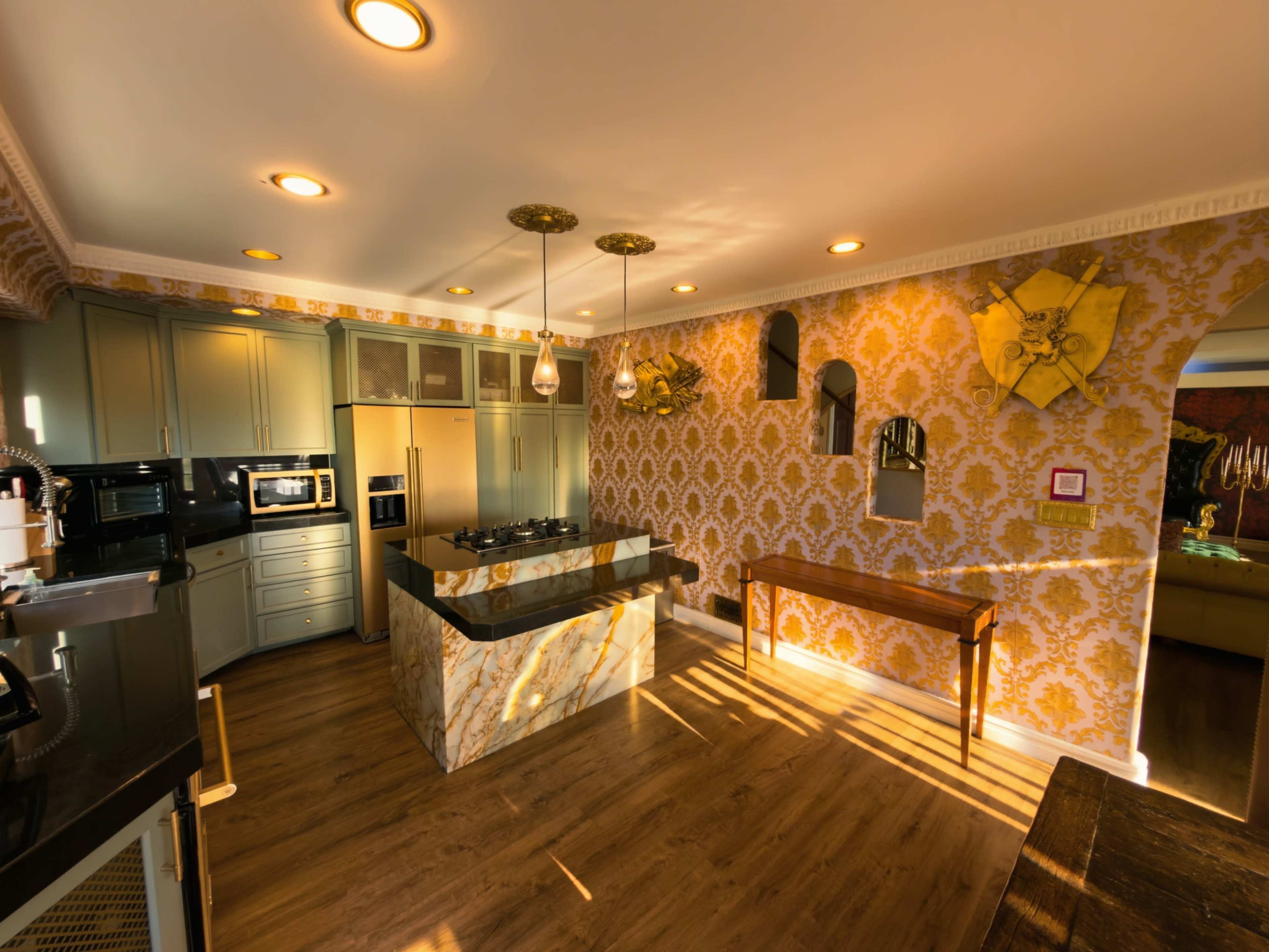 The image shows a modern kitchen featuring a marble-topped island, sleek cabinetry, and patterned yellow wallpaper.