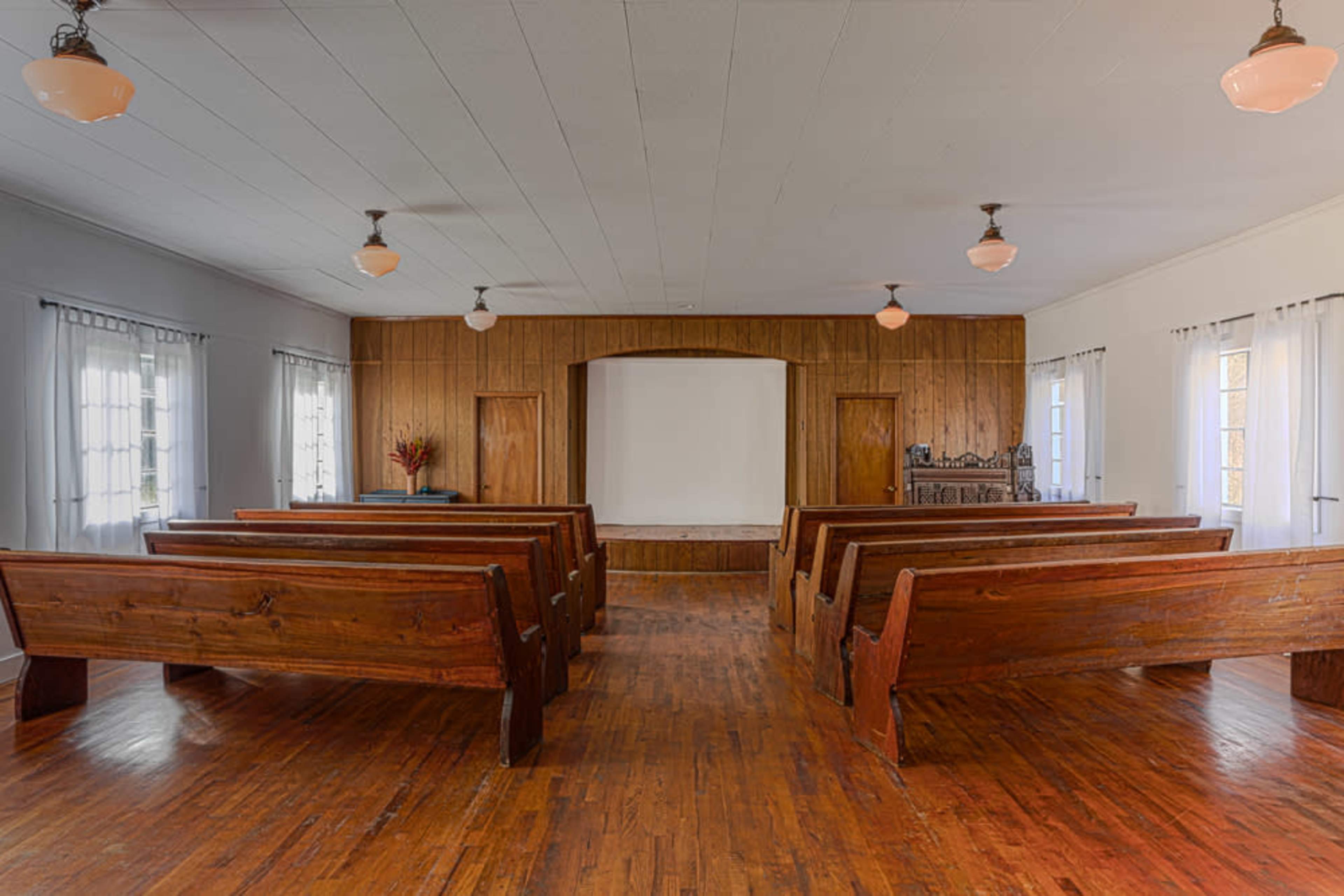 The Studio at Valle View ~ simple old church building with lots of natural light, a stage and pews, rural area Image in , Banner Elk, NC
