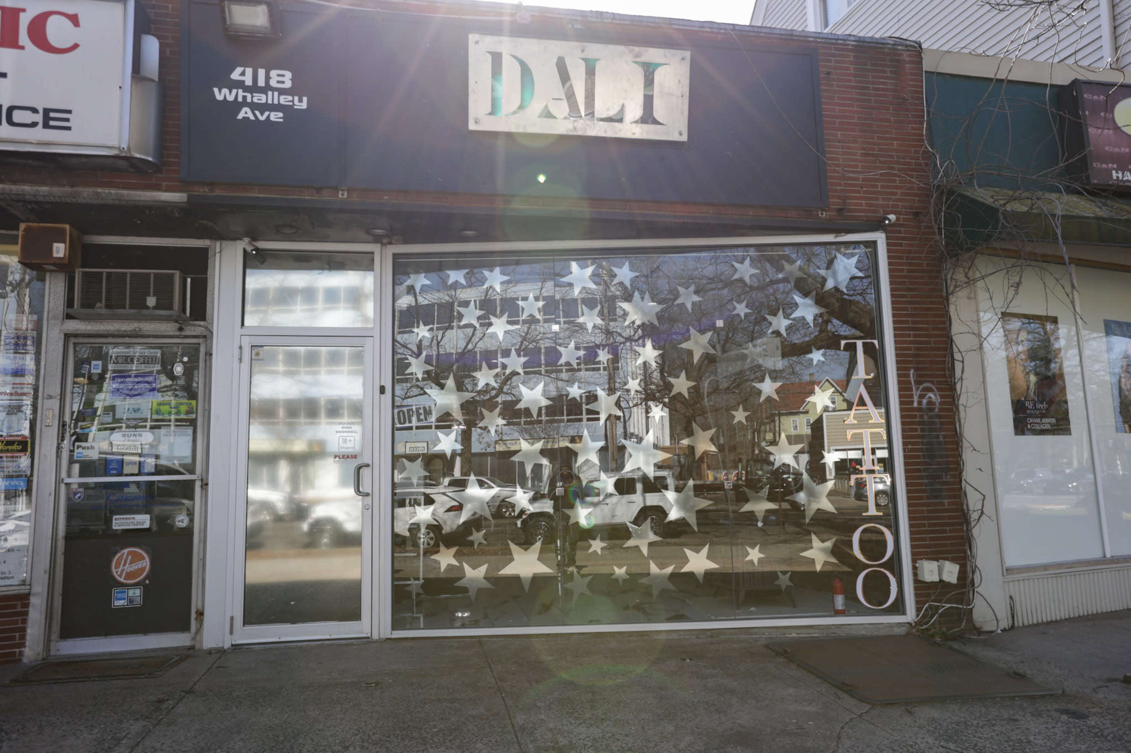 The storefront features a large window with star-shaped decorations and a sign reading "TATTOO" at 418 Whalley Ave.