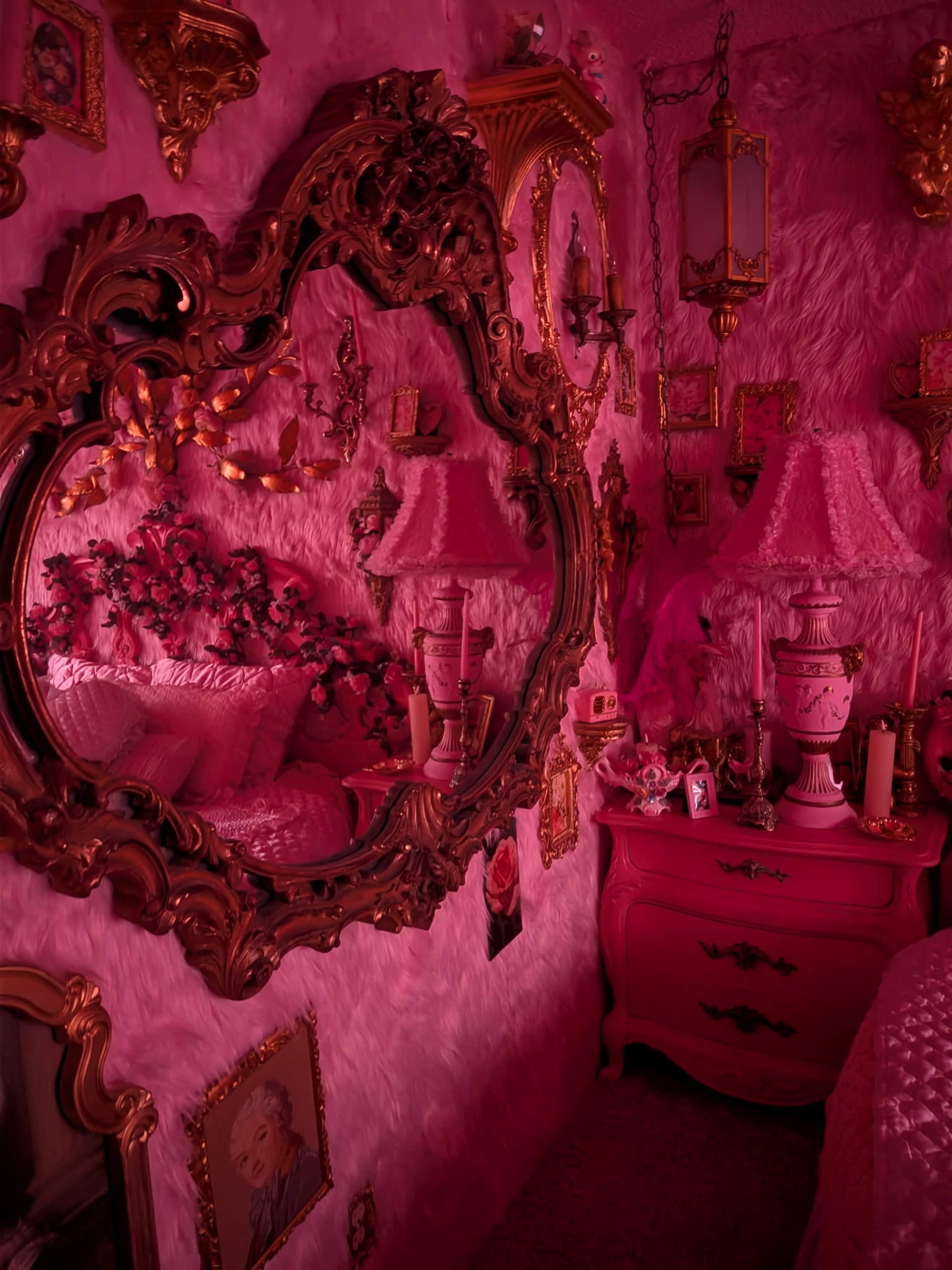The image depicts a pink-themed bedroom adorned with an ornate mirror, floral decorations, and various framed pictures on the walls.