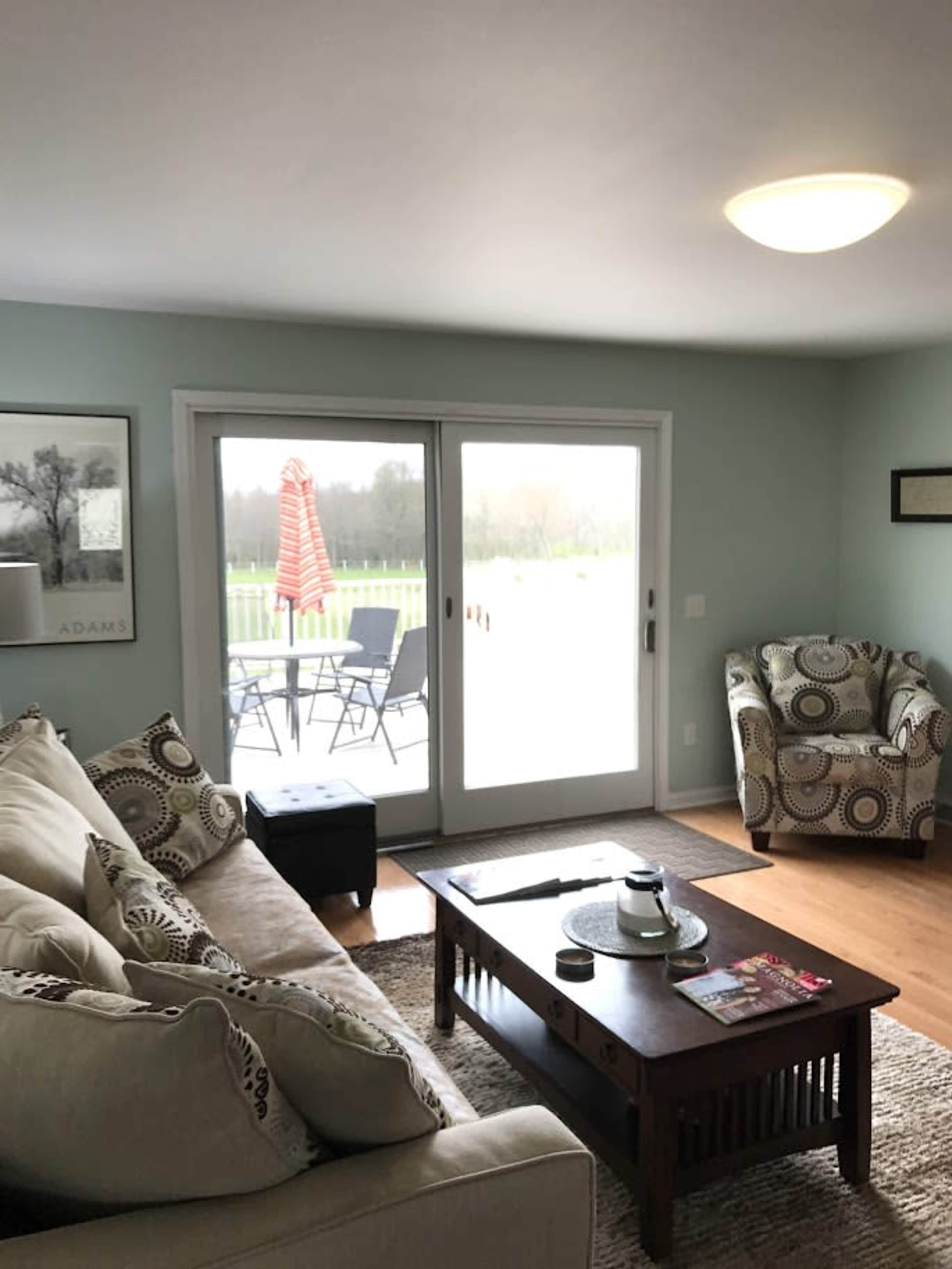 Country feel, minutes to town!   Horses surrounding the ranch, visible from all the windows in this spacious Horse Ranch home.   Outside spaces including barn, tiny home, picnic tables available to guests. Image in Ada Township, Ada, MI