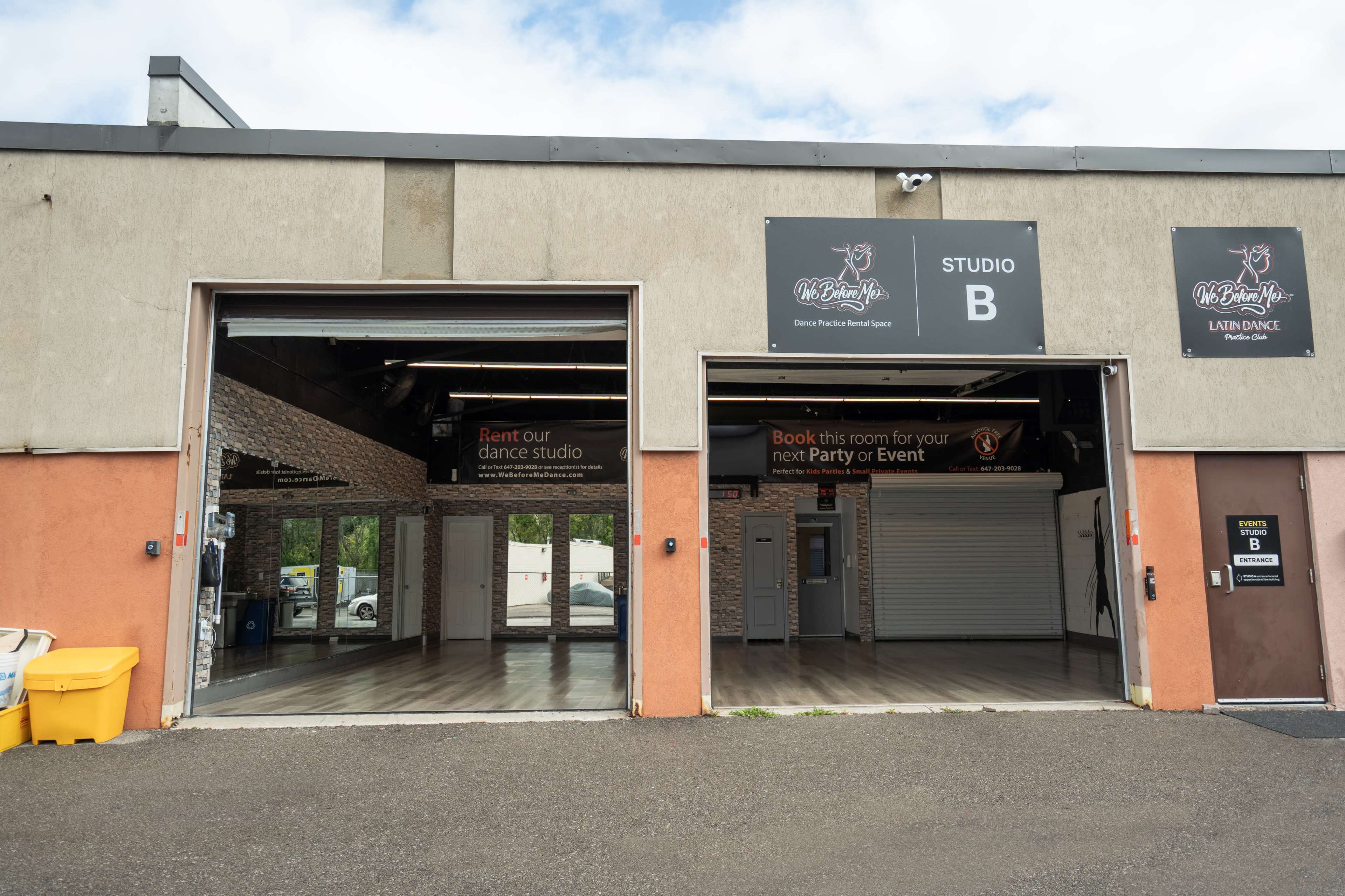 The image shows the exterior of a building featuring two open garage-style doors that lead into a dance studio labeled "STUDIO B," with advertisements for renting the space for events.