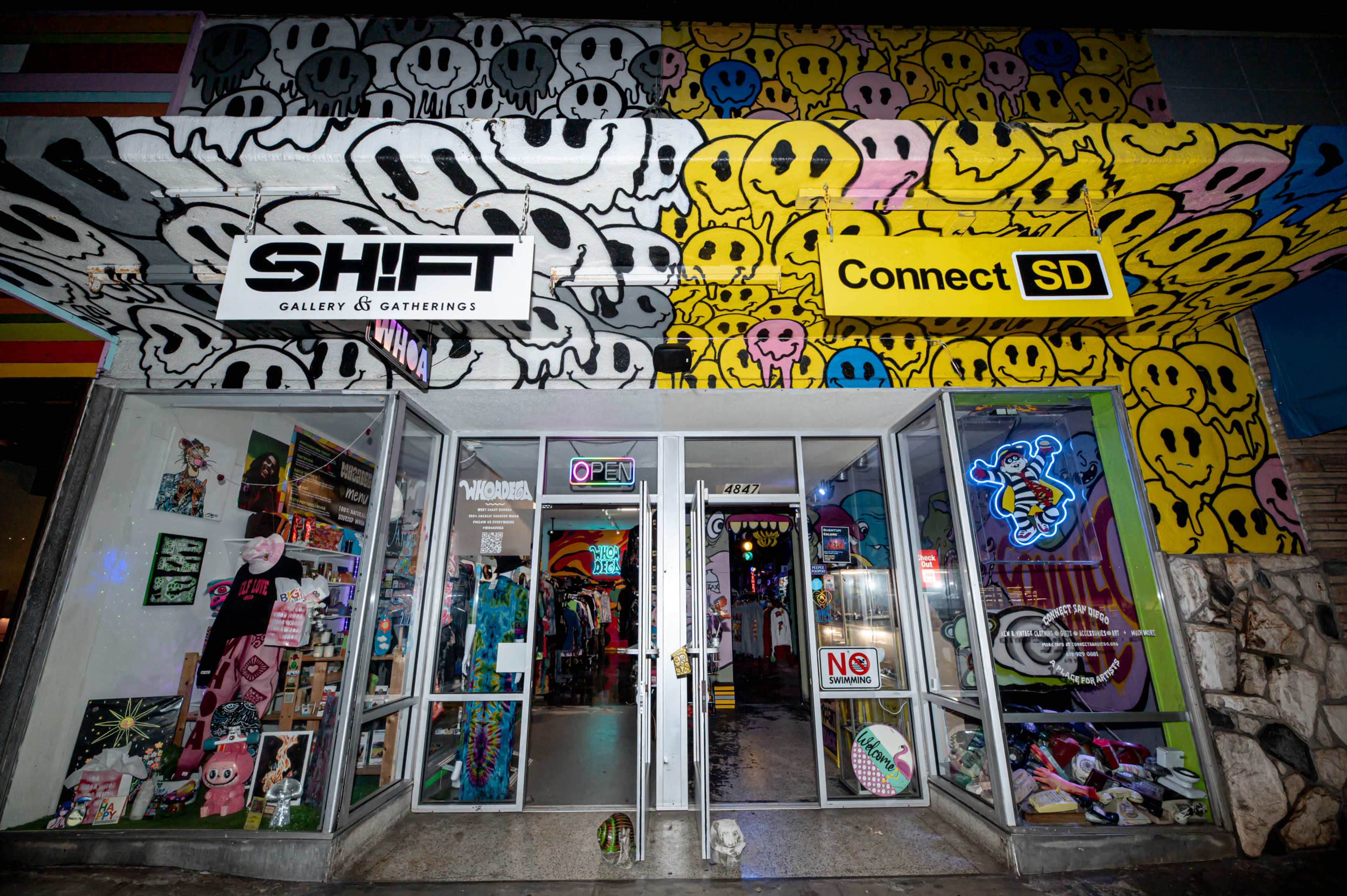 The storefront features vibrant graffiti-style art, prominently displaying the names "SHIFT" and "Connect SD," with large windows revealing a colorful interior filled with merchandise.