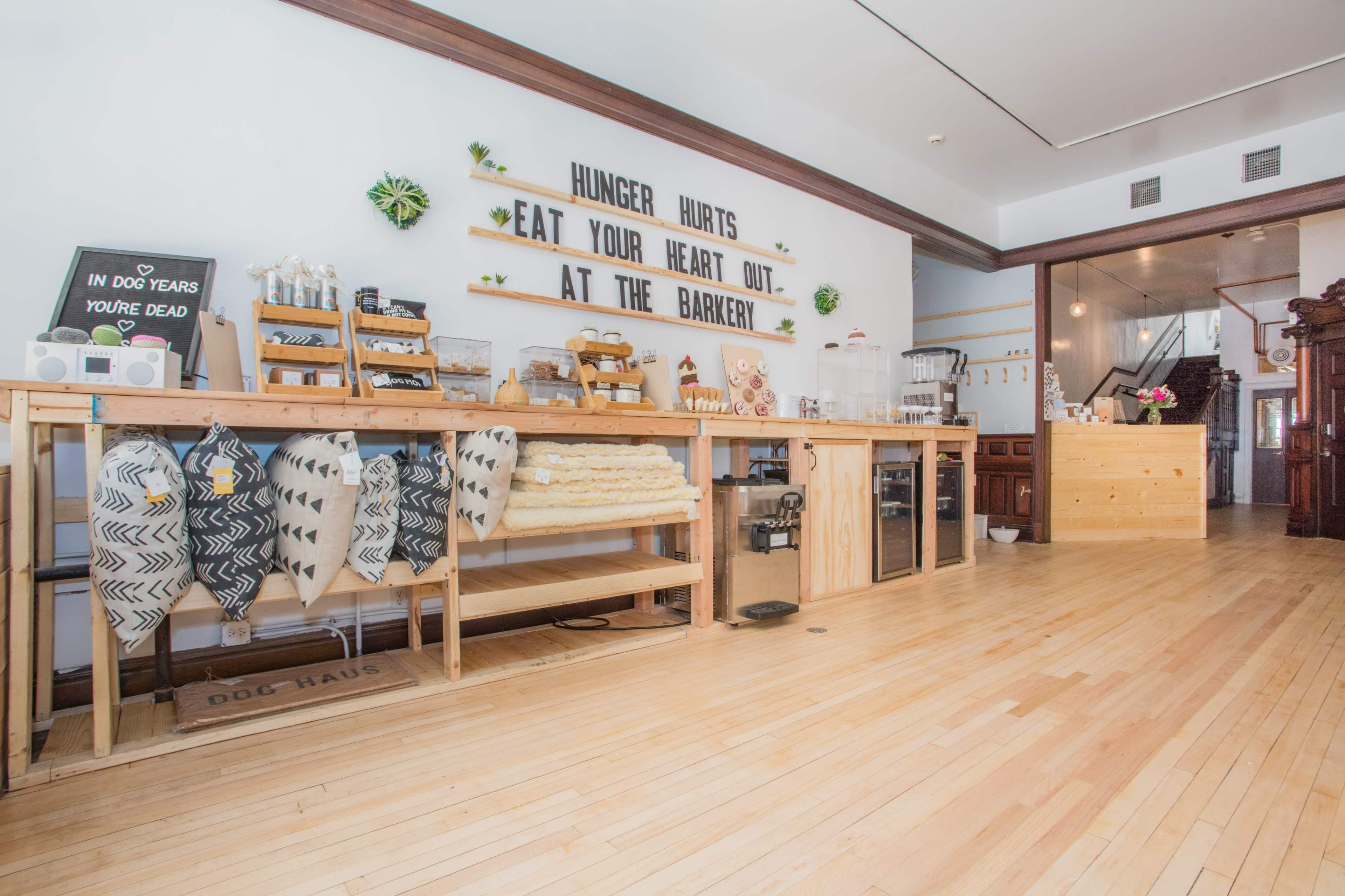 A modern bakery with wooden counters displaying various products and a welcoming interior.