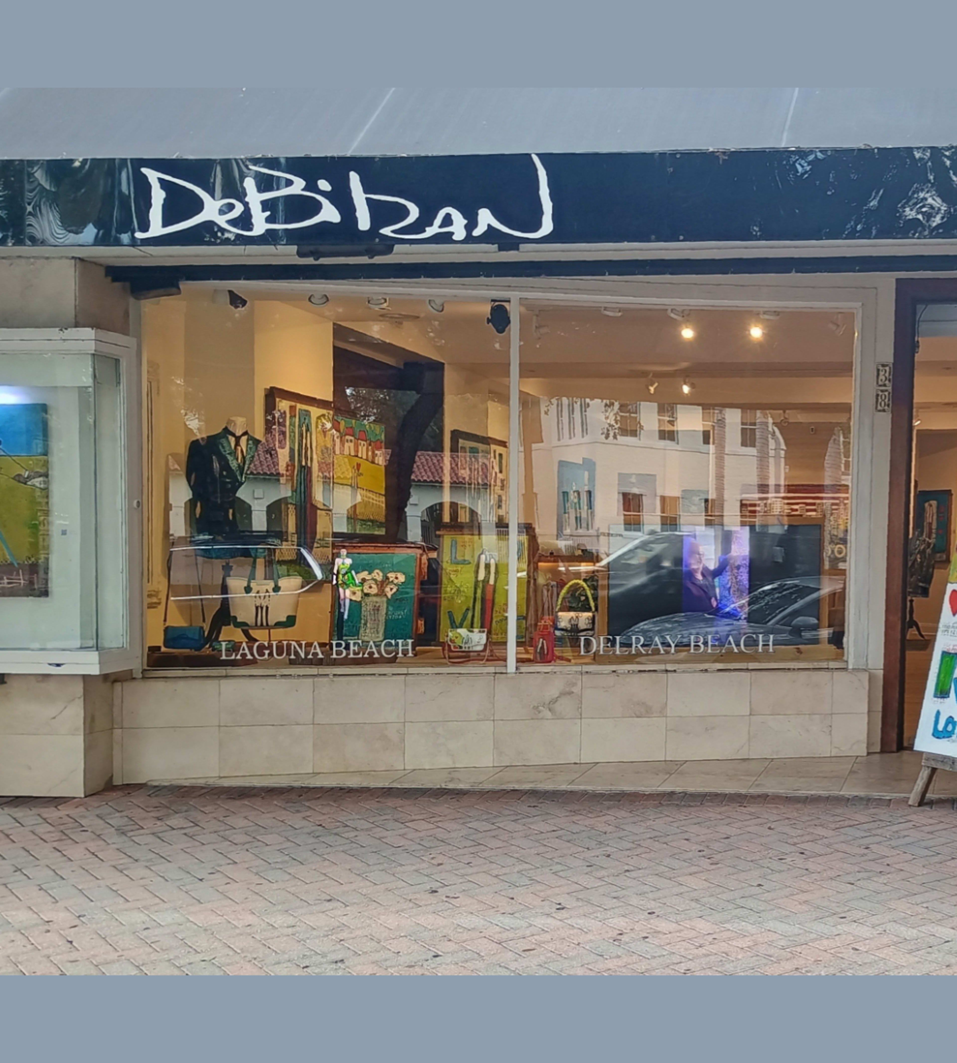 The image shows the storefront of a gallery named "DePirran" located in Delray Beach, featuring colorful artworks displayed in the windows.