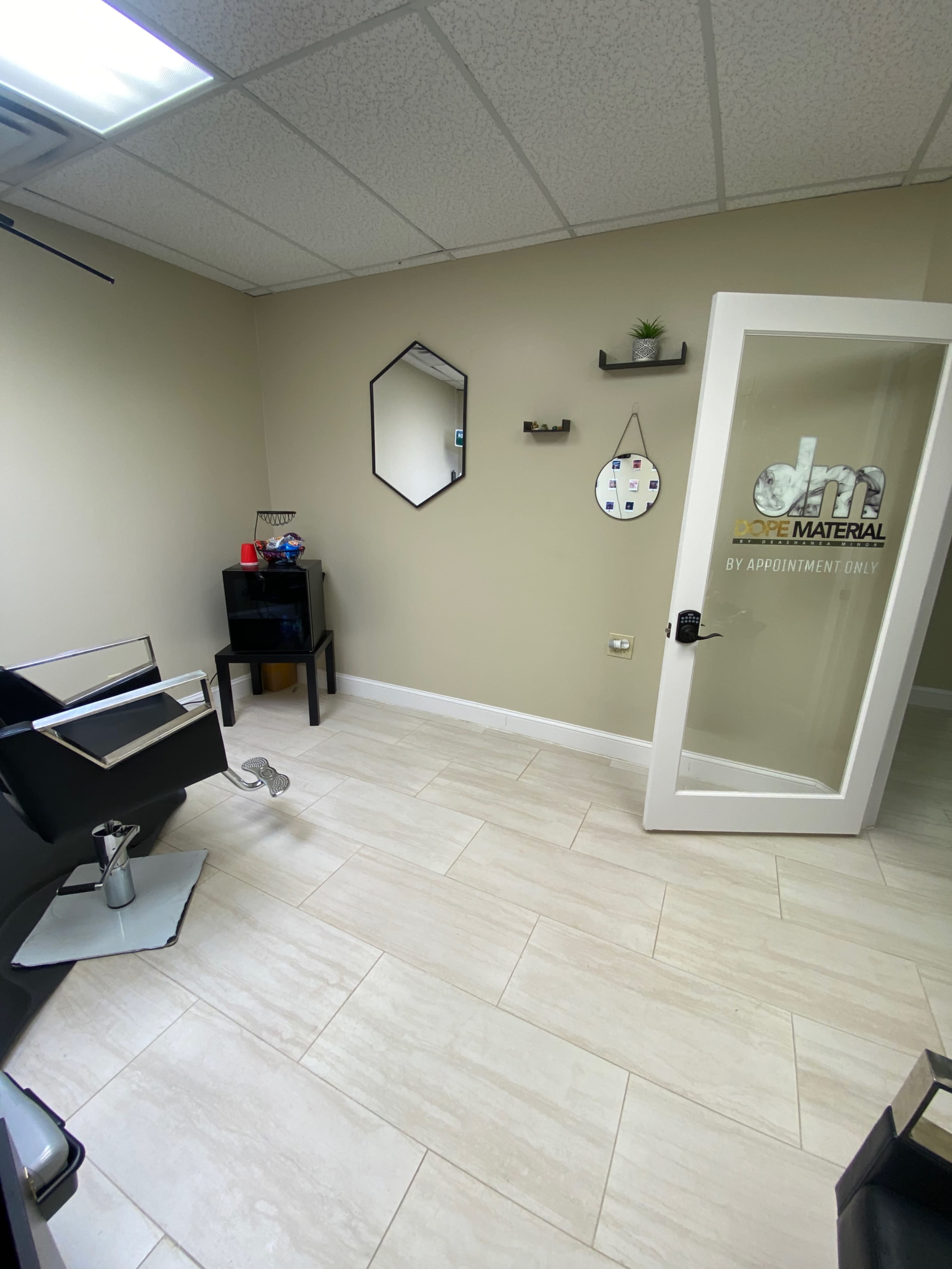 The image shows a hair salon interior with a stylist chair, a mirror, and a door labeled "by appointment only."