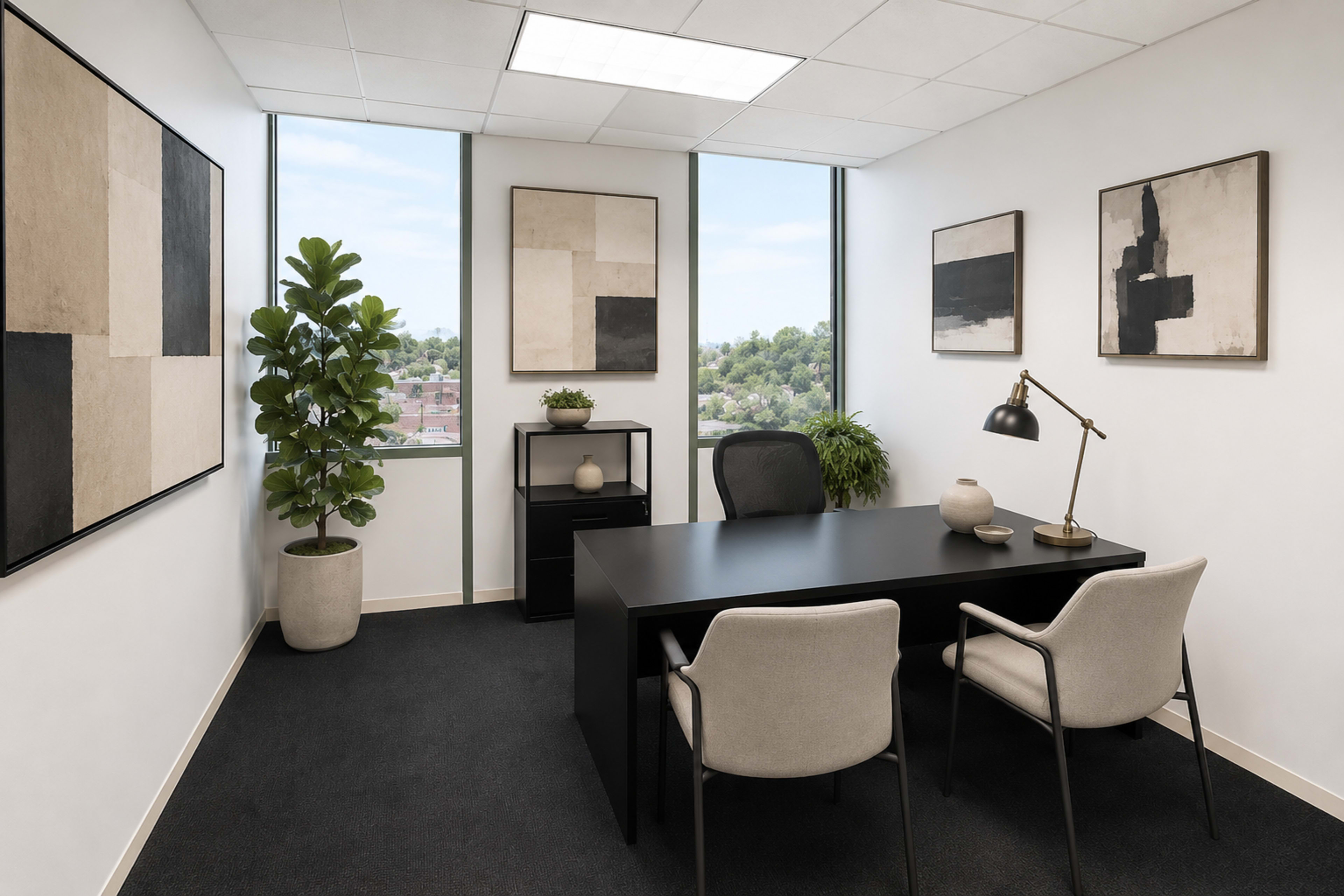 The image depicts a modern office space with large windows, a black desk, two upholstered chairs, and abstract artwork on the walls.