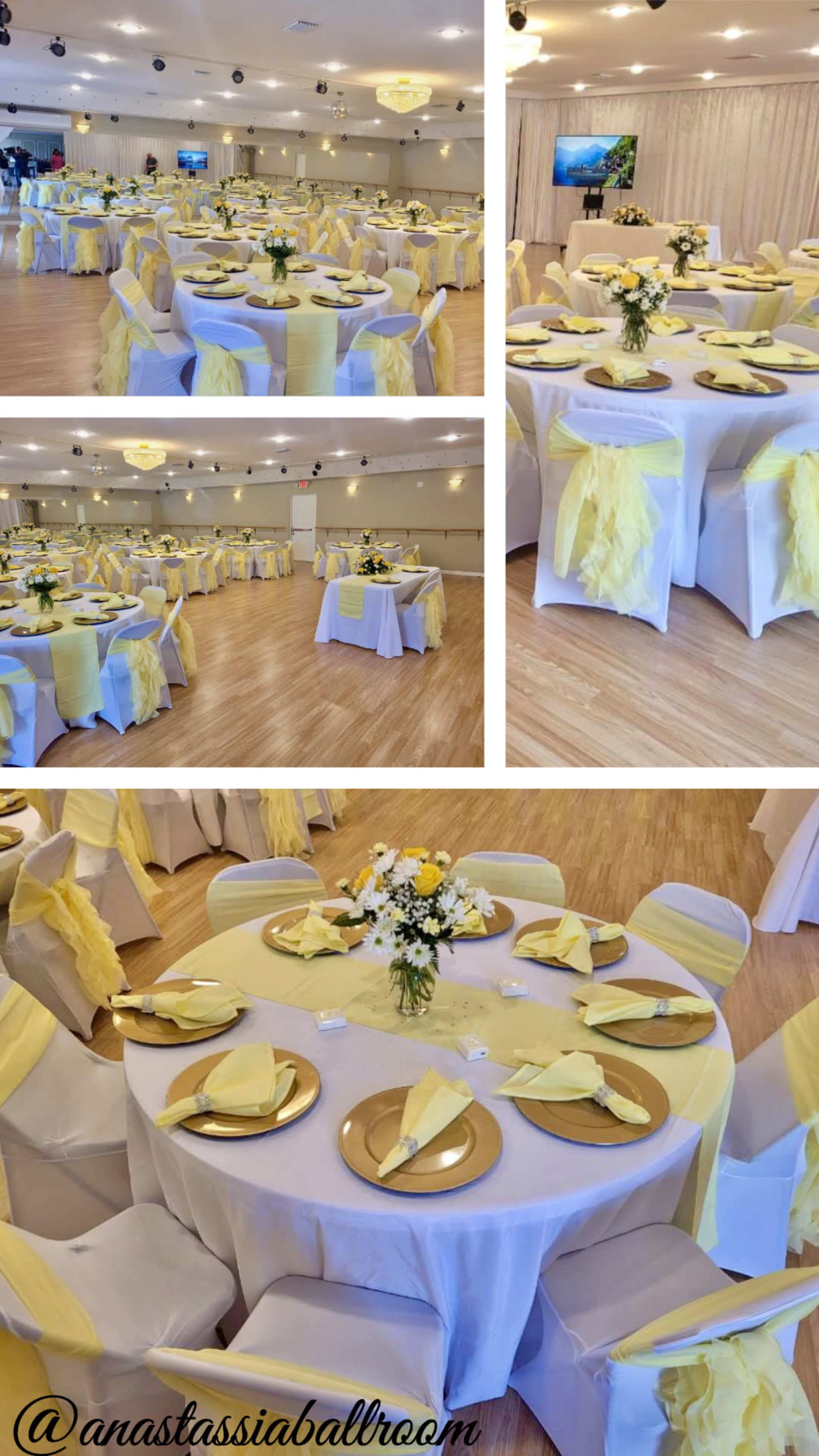 The image shows a spacious banquet hall arranged with round tables dressed in white tablecloths and yellow decorations, featuring floral centerpieces and gold plates.