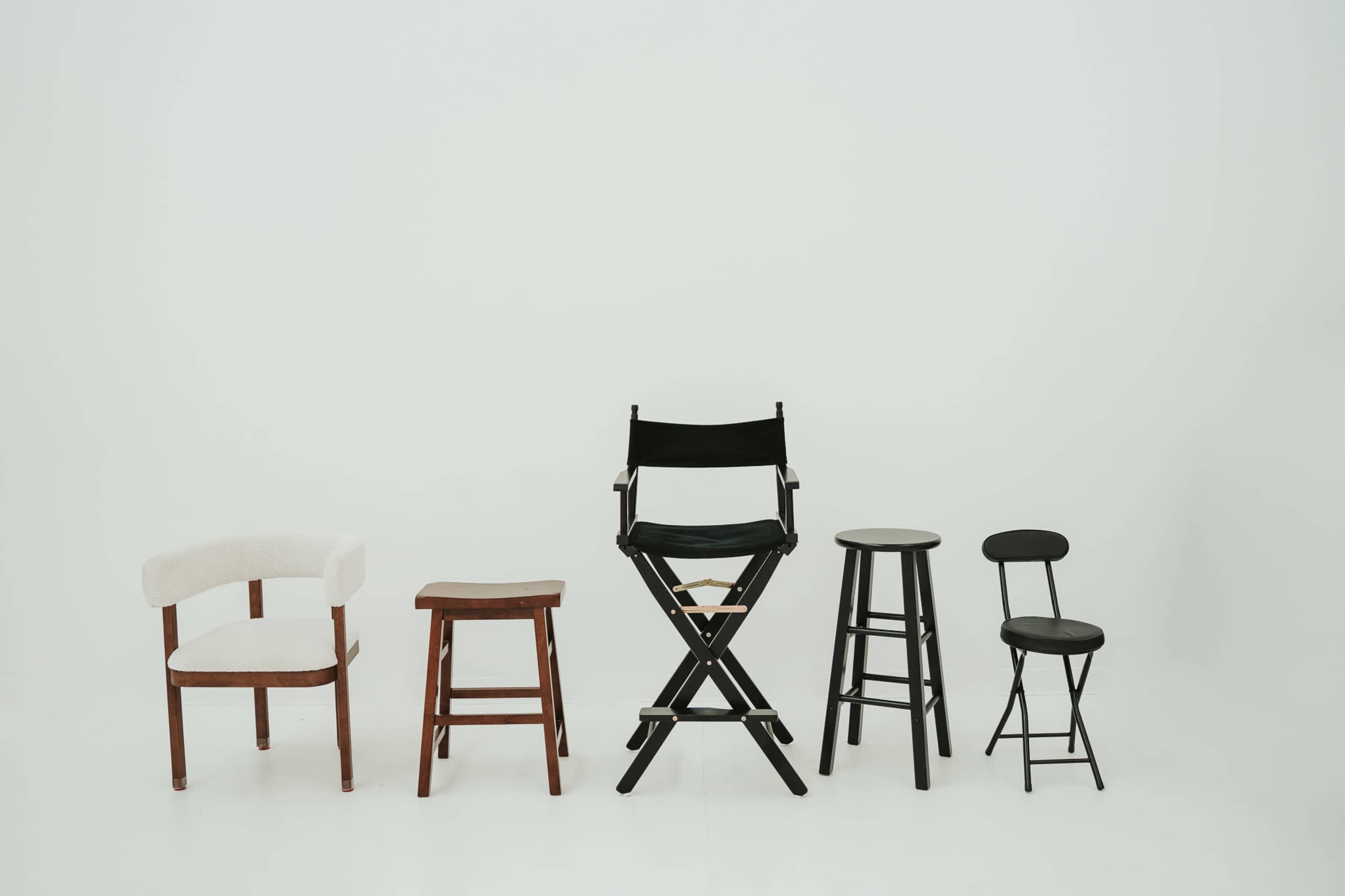 Five different styles of chairs are arranged in a line against a plain white background.