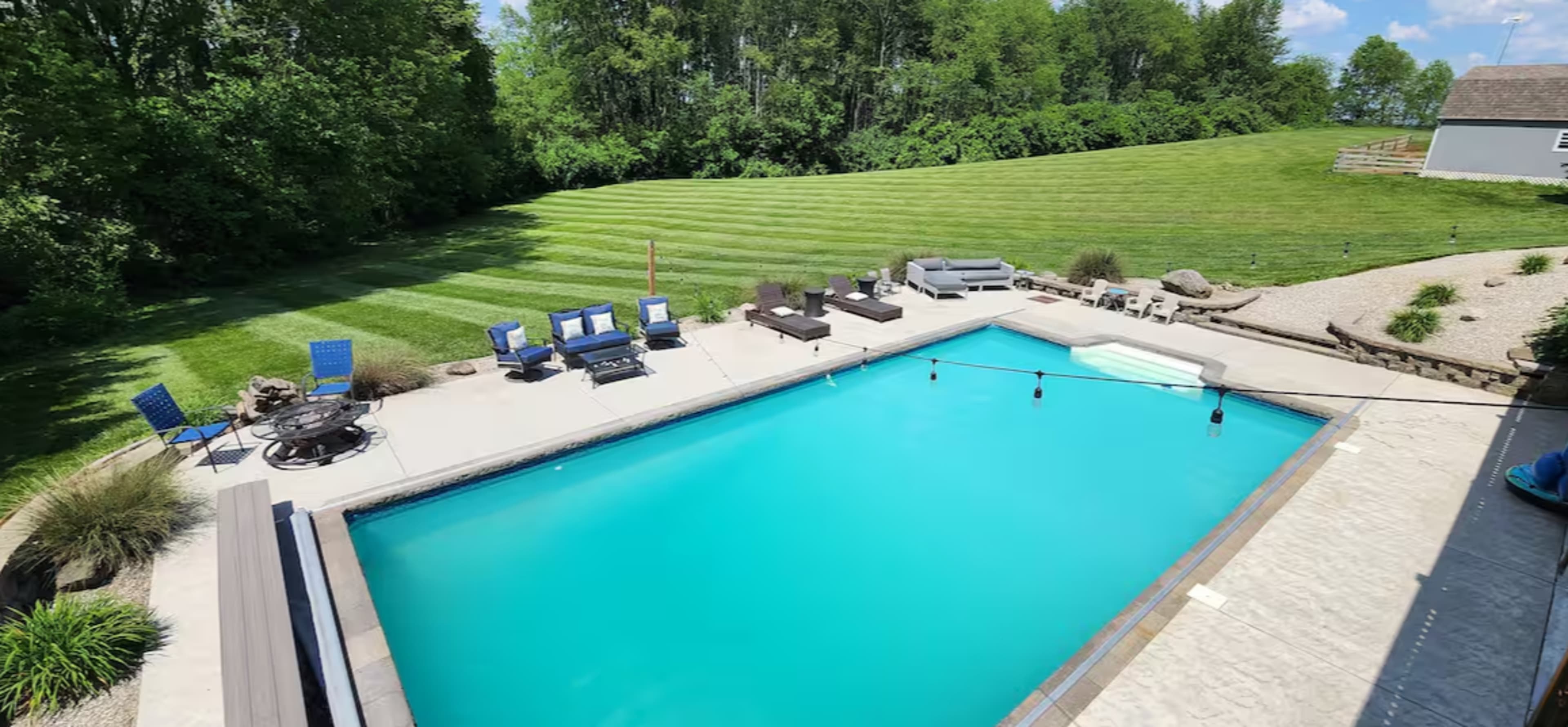 Beautiful farmhouse setting with huge inground pool with walkout basement. Image in Clark Township, Greenwood, IN