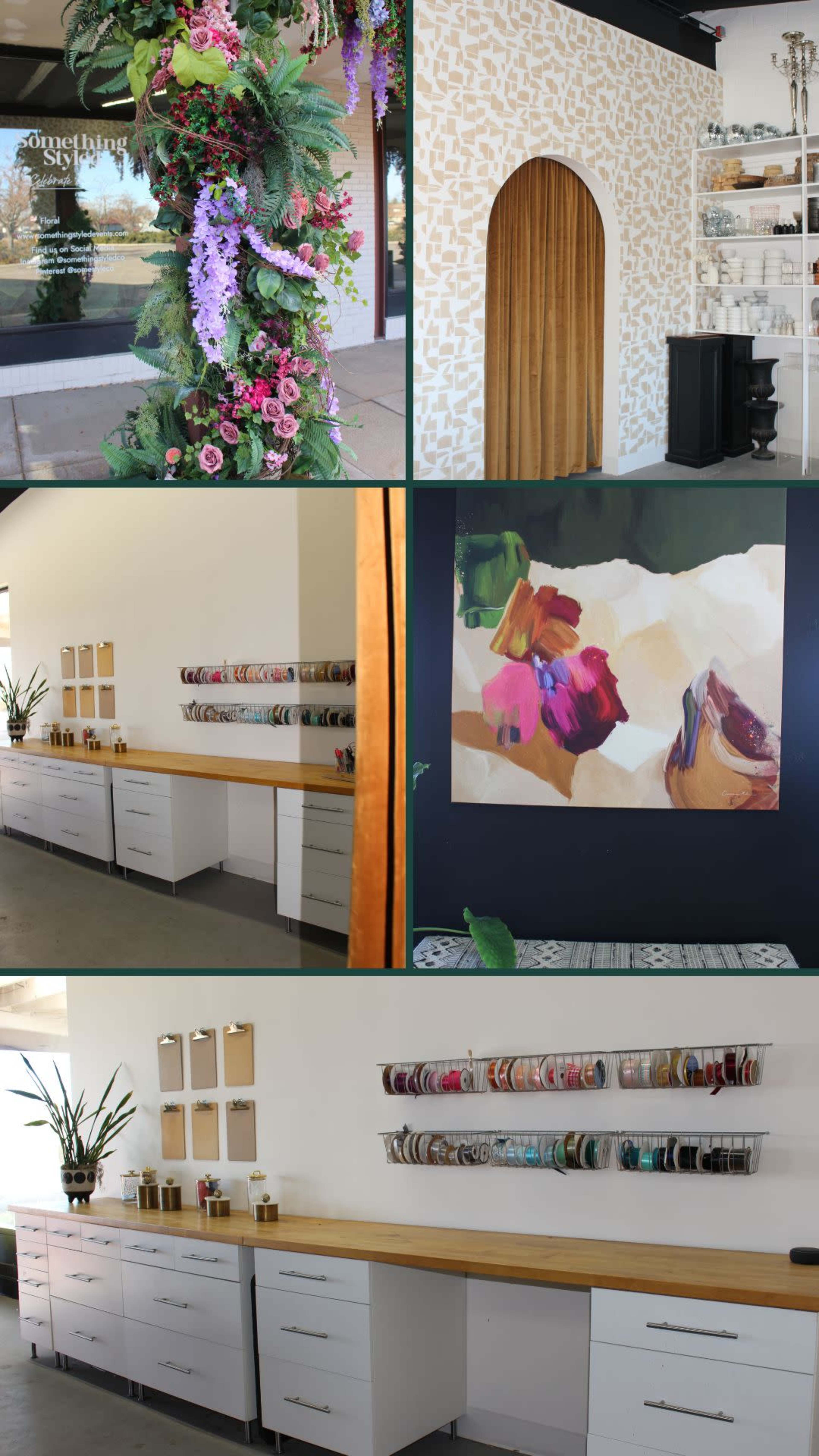 The image features a well-organized workspace with a decorative wall, a floral arch, a wooden countertop for crafting, and shelves displaying various materials and tools.