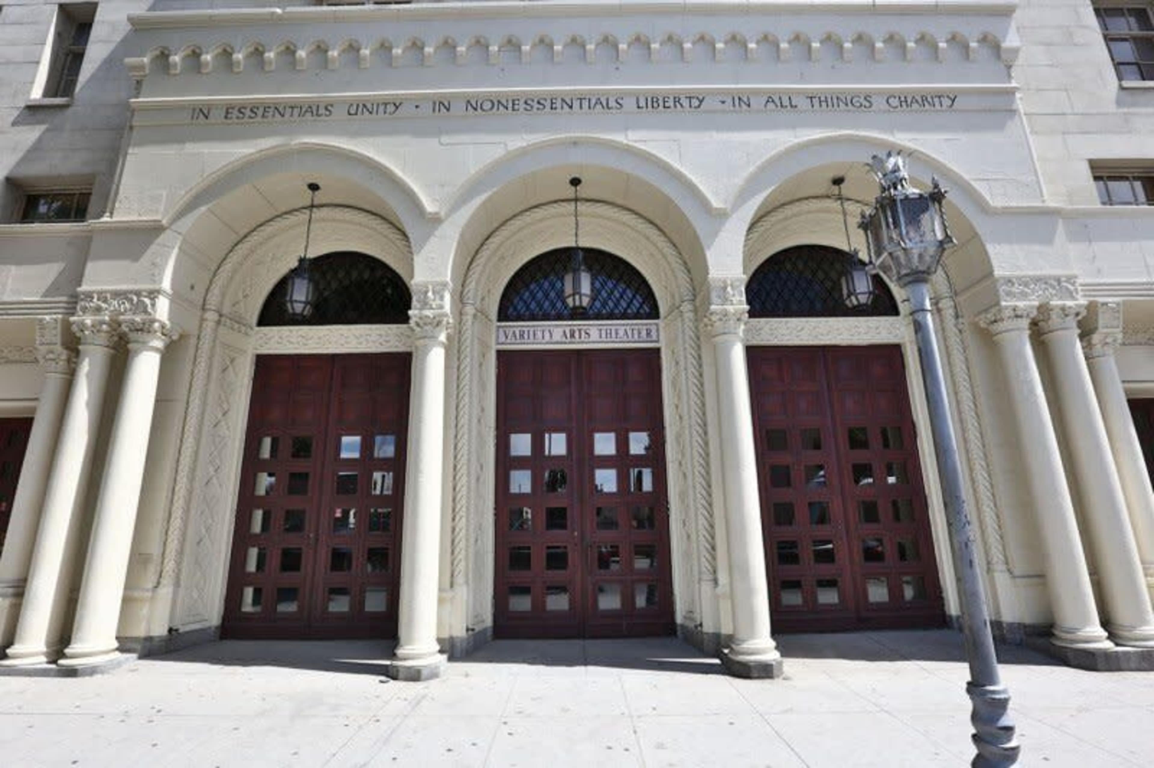 The entrance of the Nabbey Arts Theater, featuring arched doorways and decorative columns.