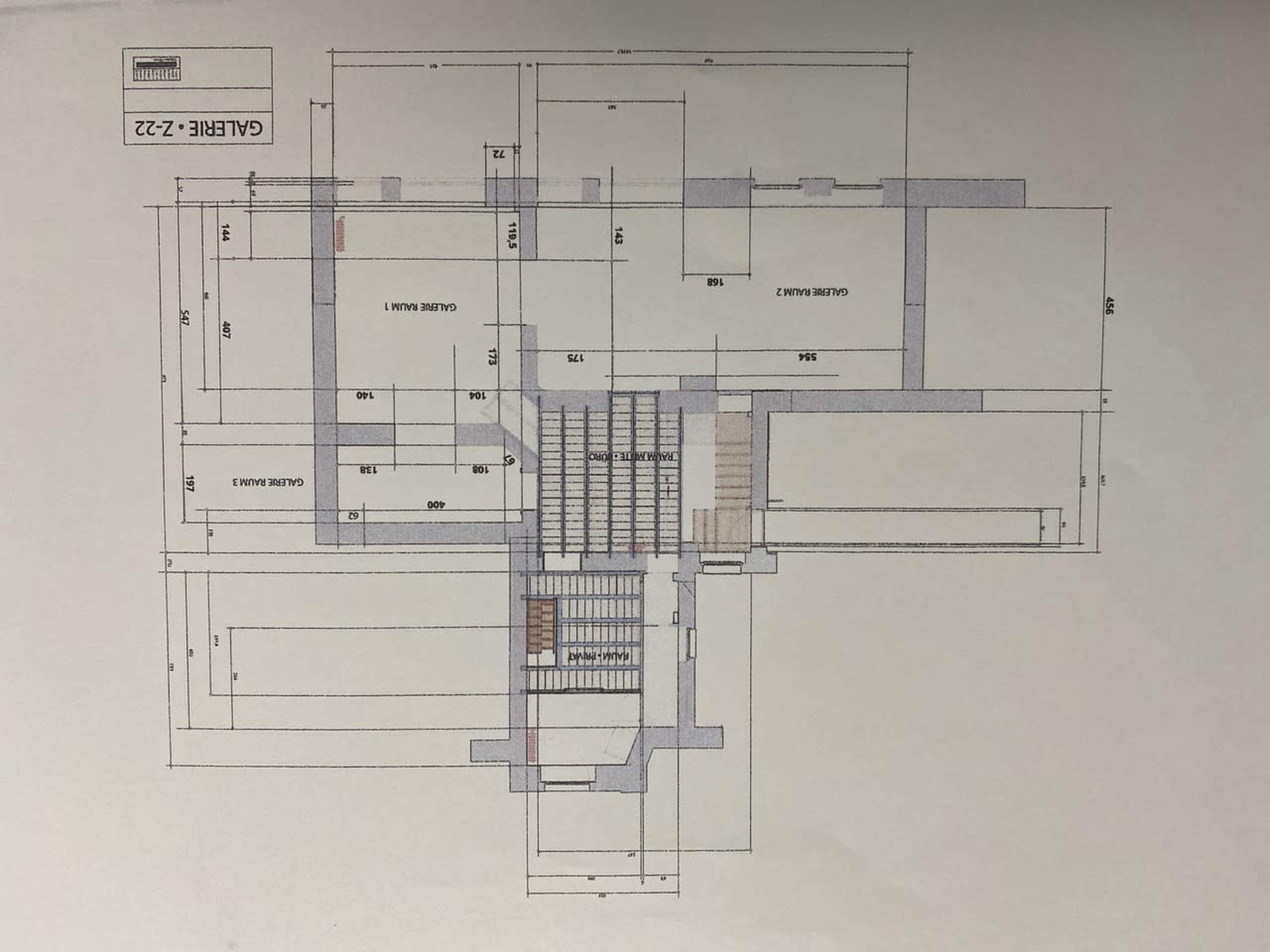 A detailed architectural floor plan labeled "GALLERY - 1-22," featuring various rooms and staircases with measurements indicated.