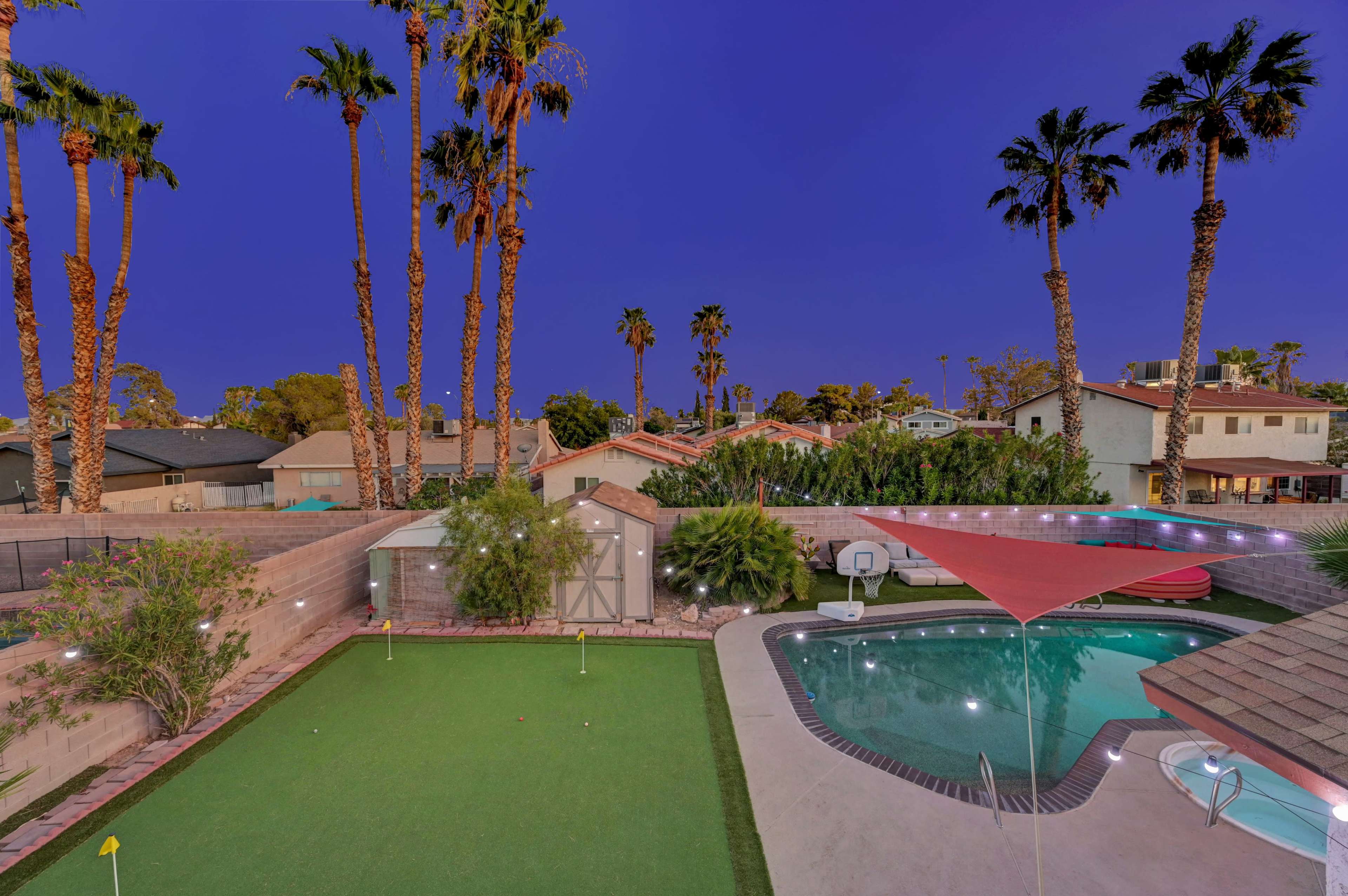 Oasis backyard with putting green, pool/spa/patio area/color string lights etc. Image in Spring Valley, las vegas, NV
