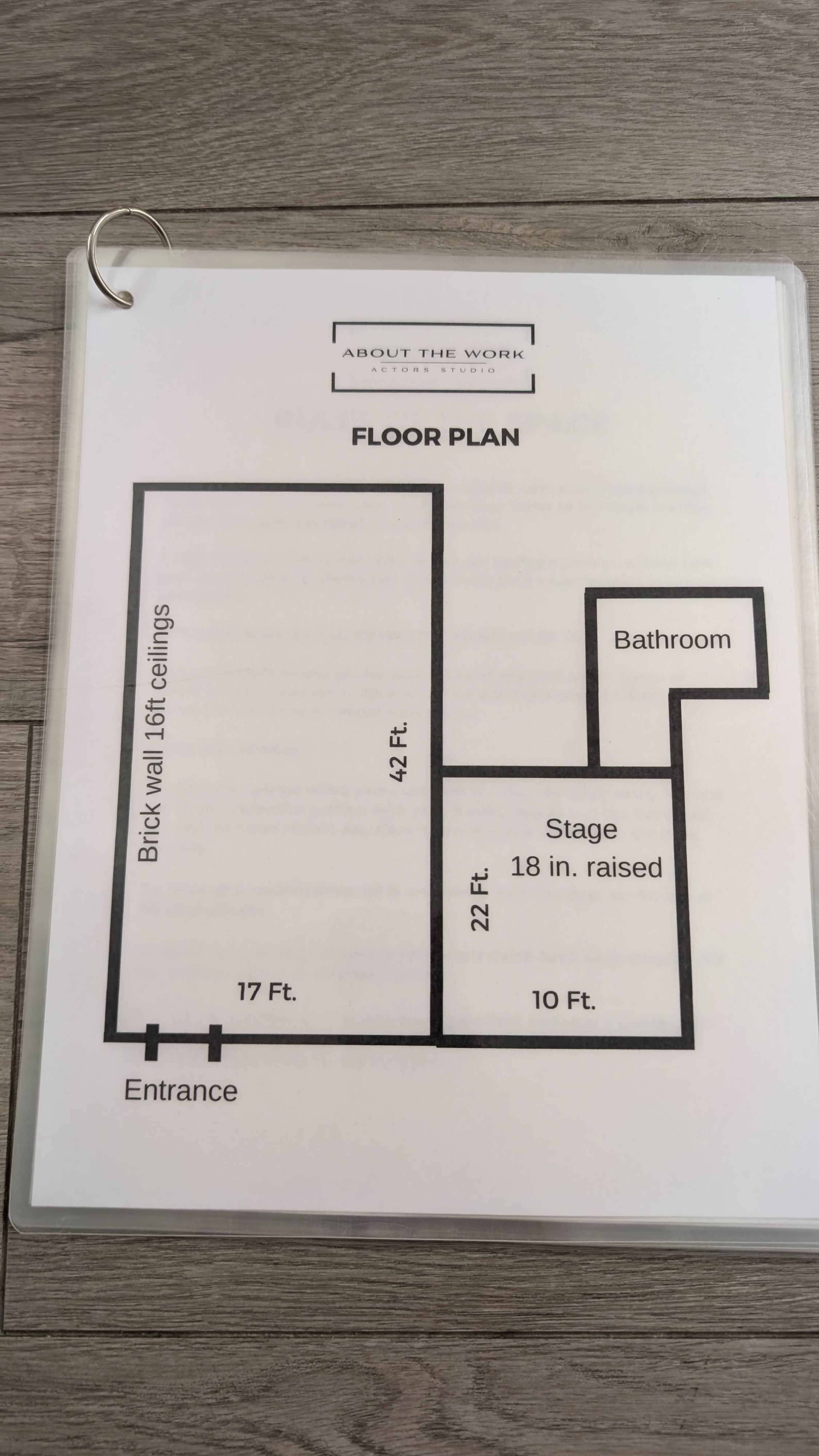The image shows a floor plan with labeled dimensions for a space that includes an entrance, a stage, a bathroom, and a brick wall.