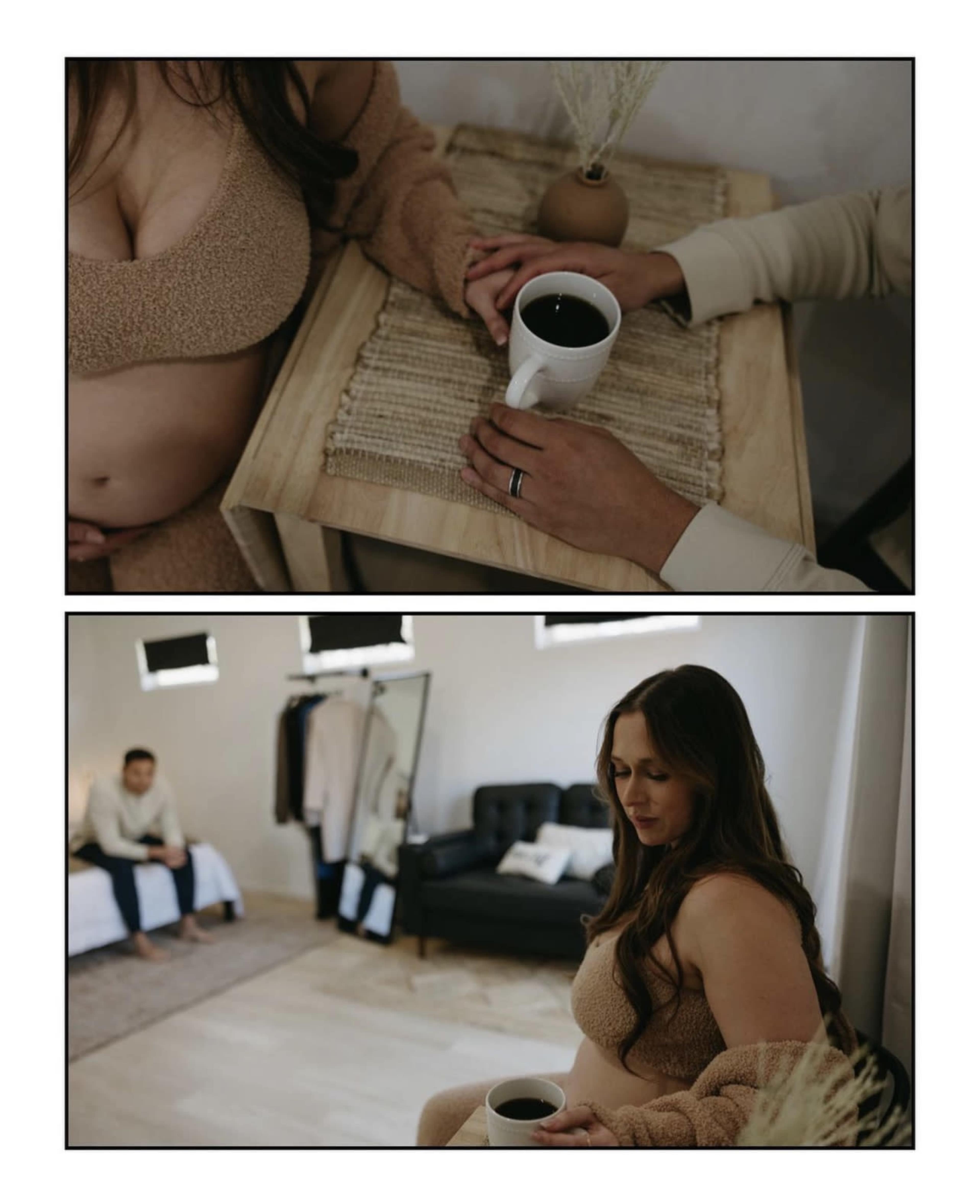 A woman sits at a table holding a mug, while another person sits in the background on a couch.