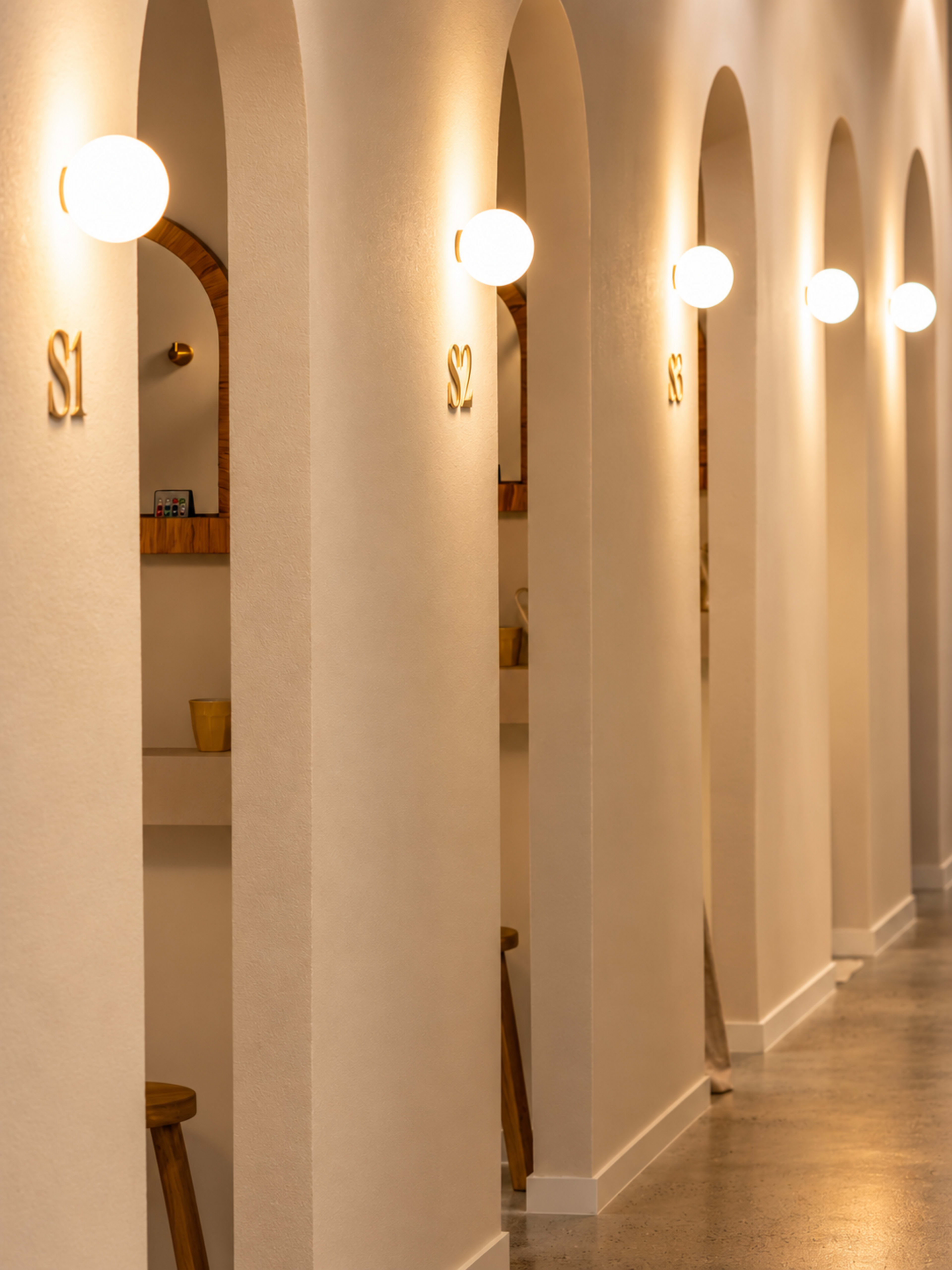 The image shows a corridor with a series of archways, each labeled with a number, and illuminated by spherical light fixtures.