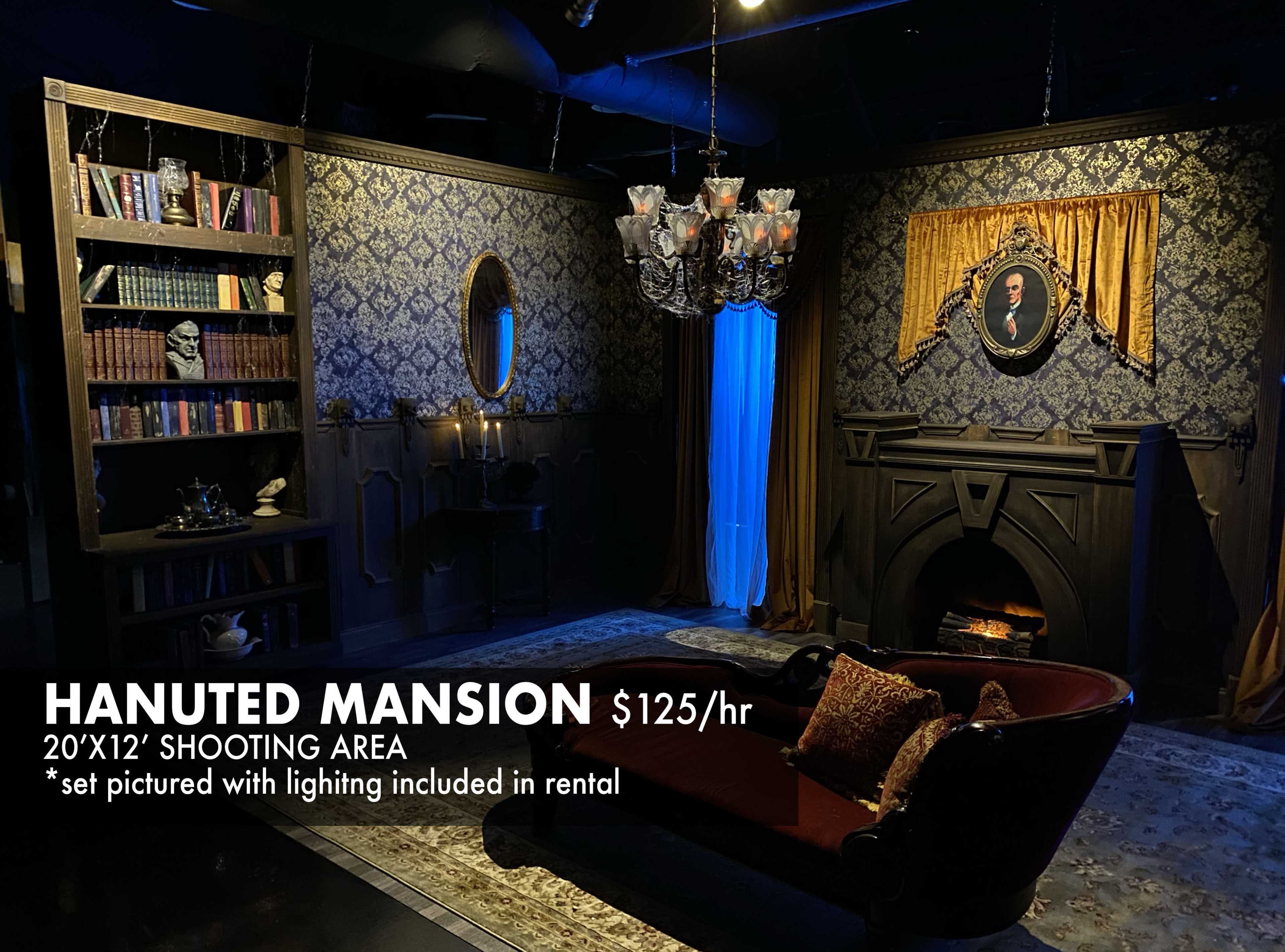 A dimly lit room designed as a haunted mansion, featuring ornate dark wallpaper, a vintage couch, a fireplace, and decorative elements like bookshelves and portraits.
