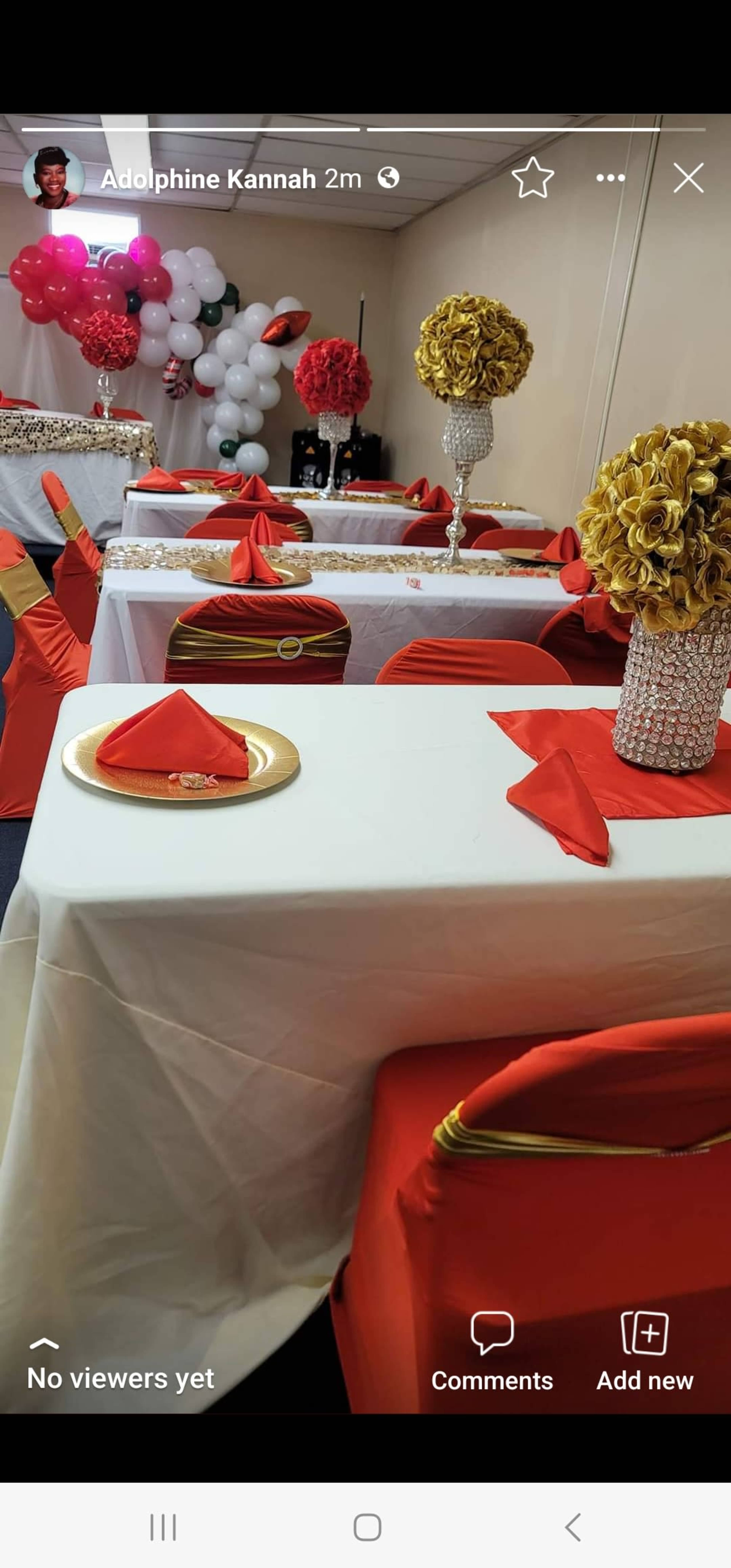 A decorated party venue with tables set with white tablecloths, red napkins, and floral centerpieces, surrounded by balloons.