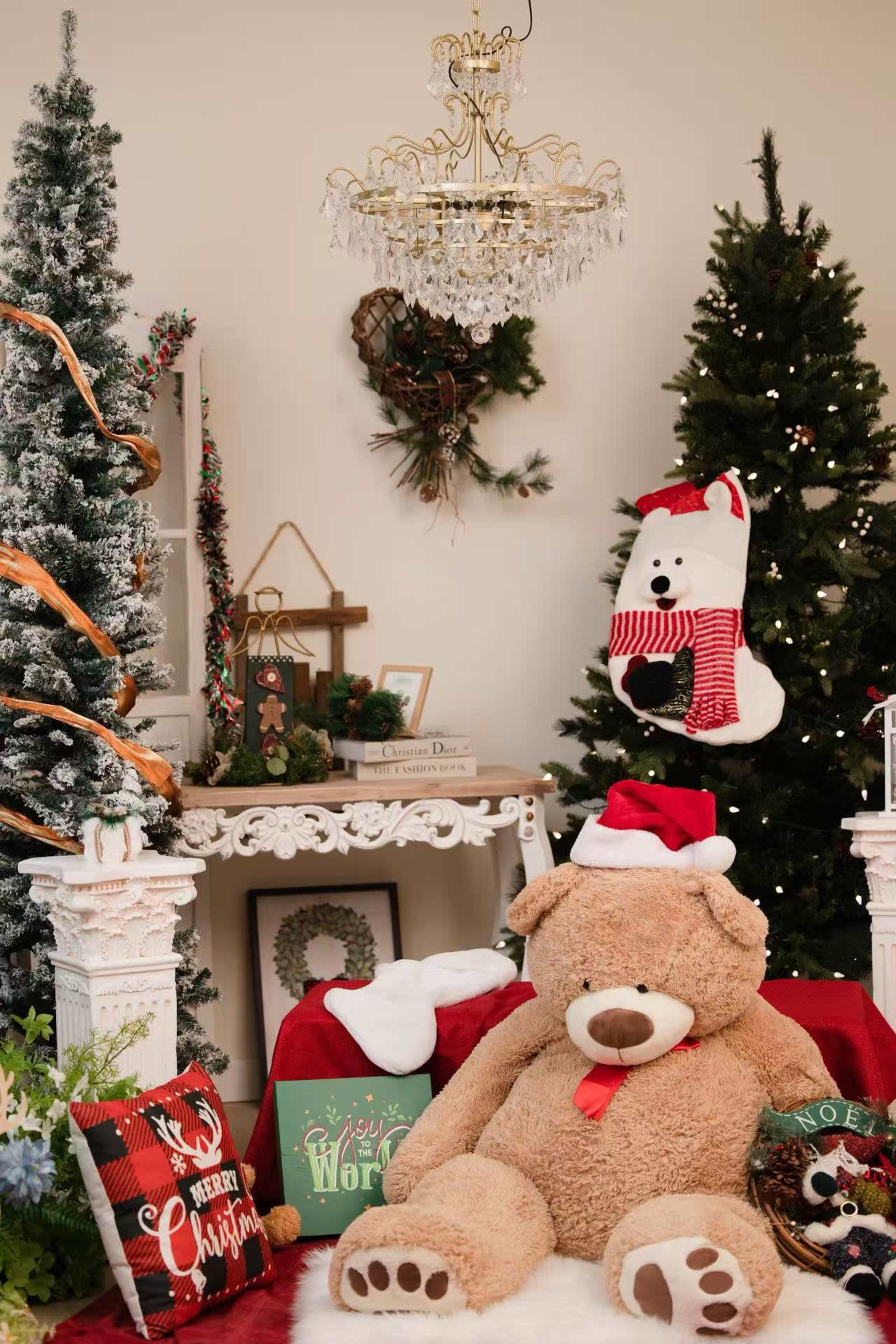 The scene features a cozy holiday-themed room with a large teddy bear wearing a Santa hat, decorated Christmas trees, and festive decorations, including stockings and pillows.