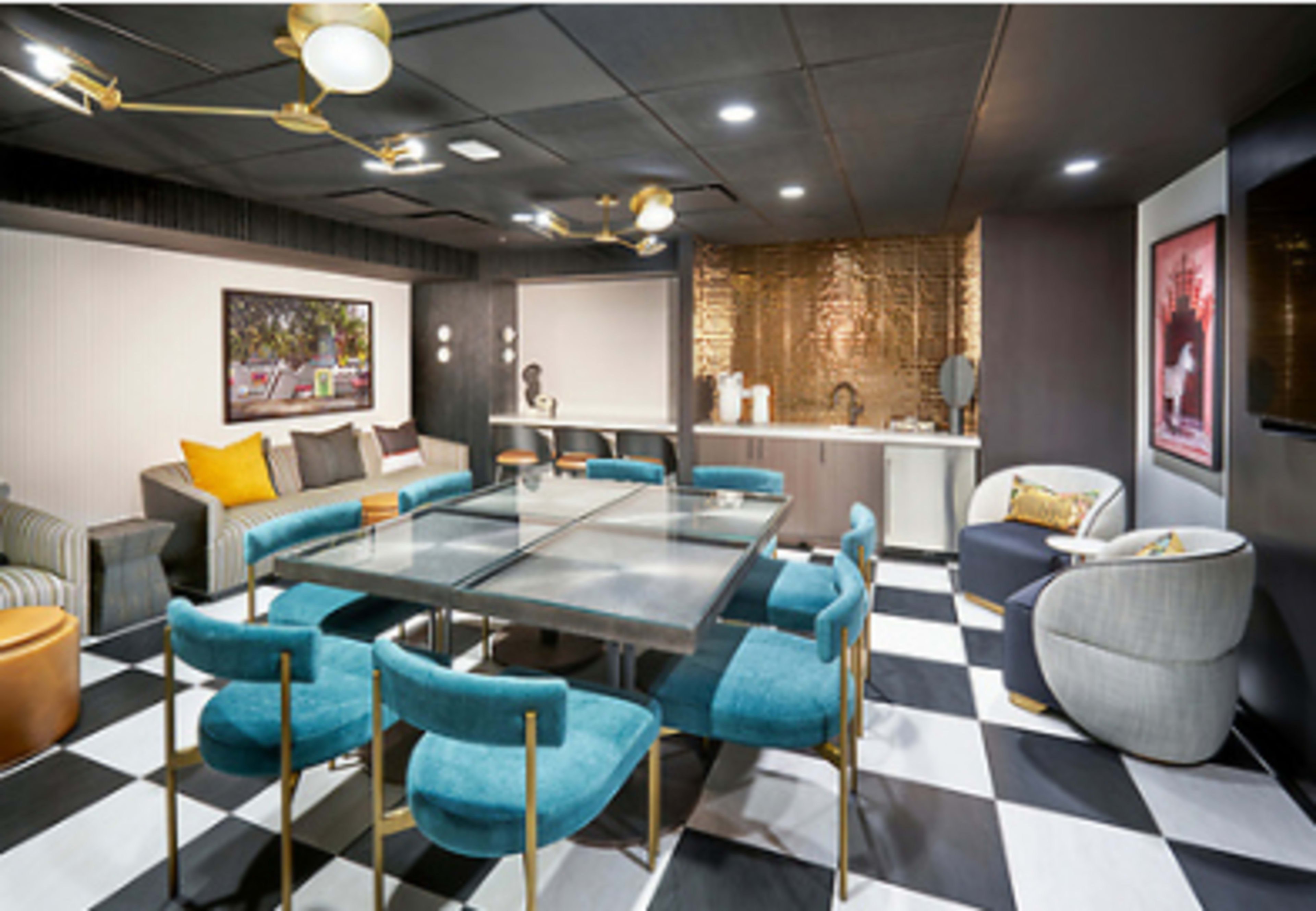 The image depicts a modern meeting room featuring a glass table surrounded by blue chairs, patterned flooring, and stylish decor elements.