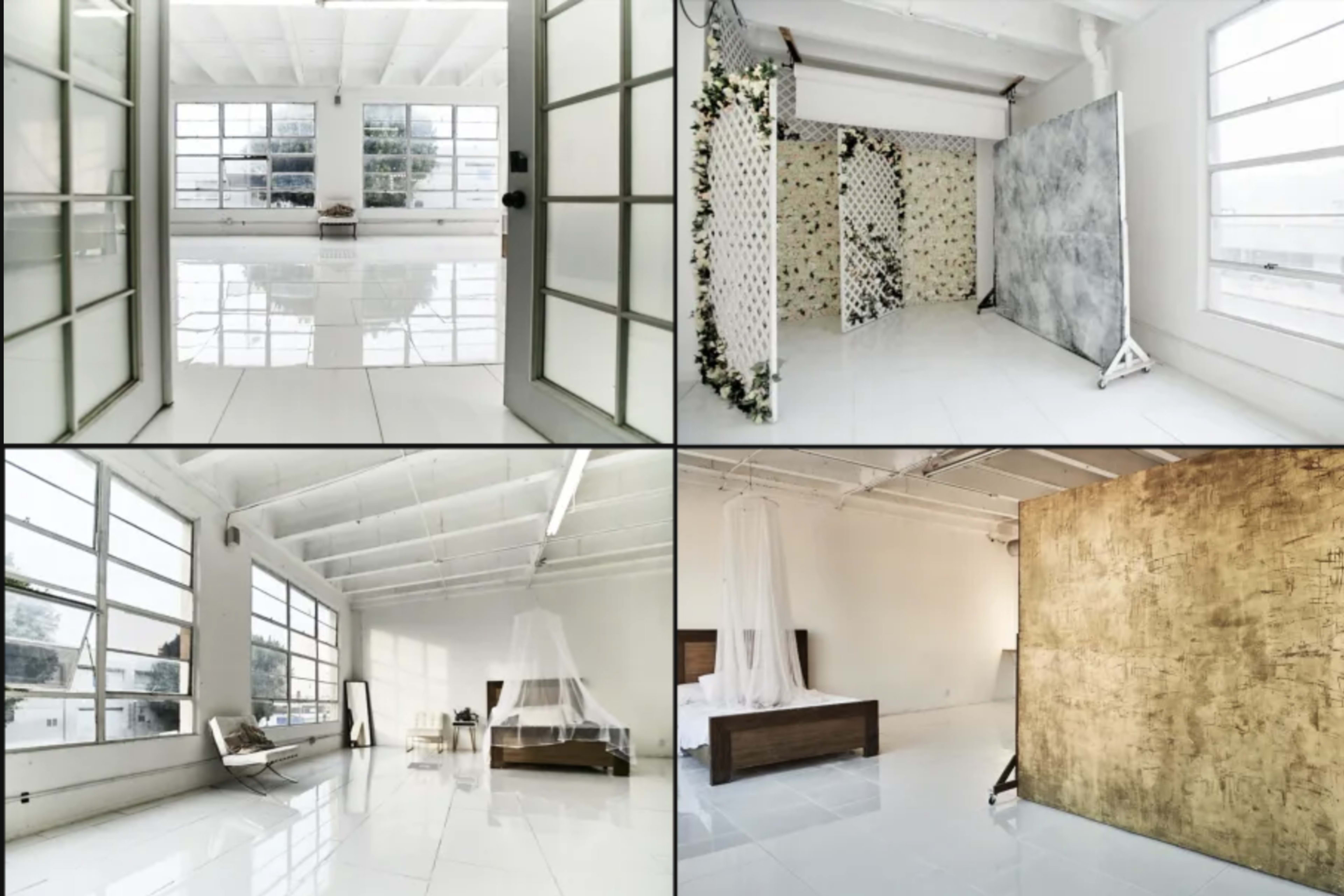 The image shows a bright, spacious interior with large windows and white walls, featuring different areas designed for photography, including backgrounds and furniture arrangements.