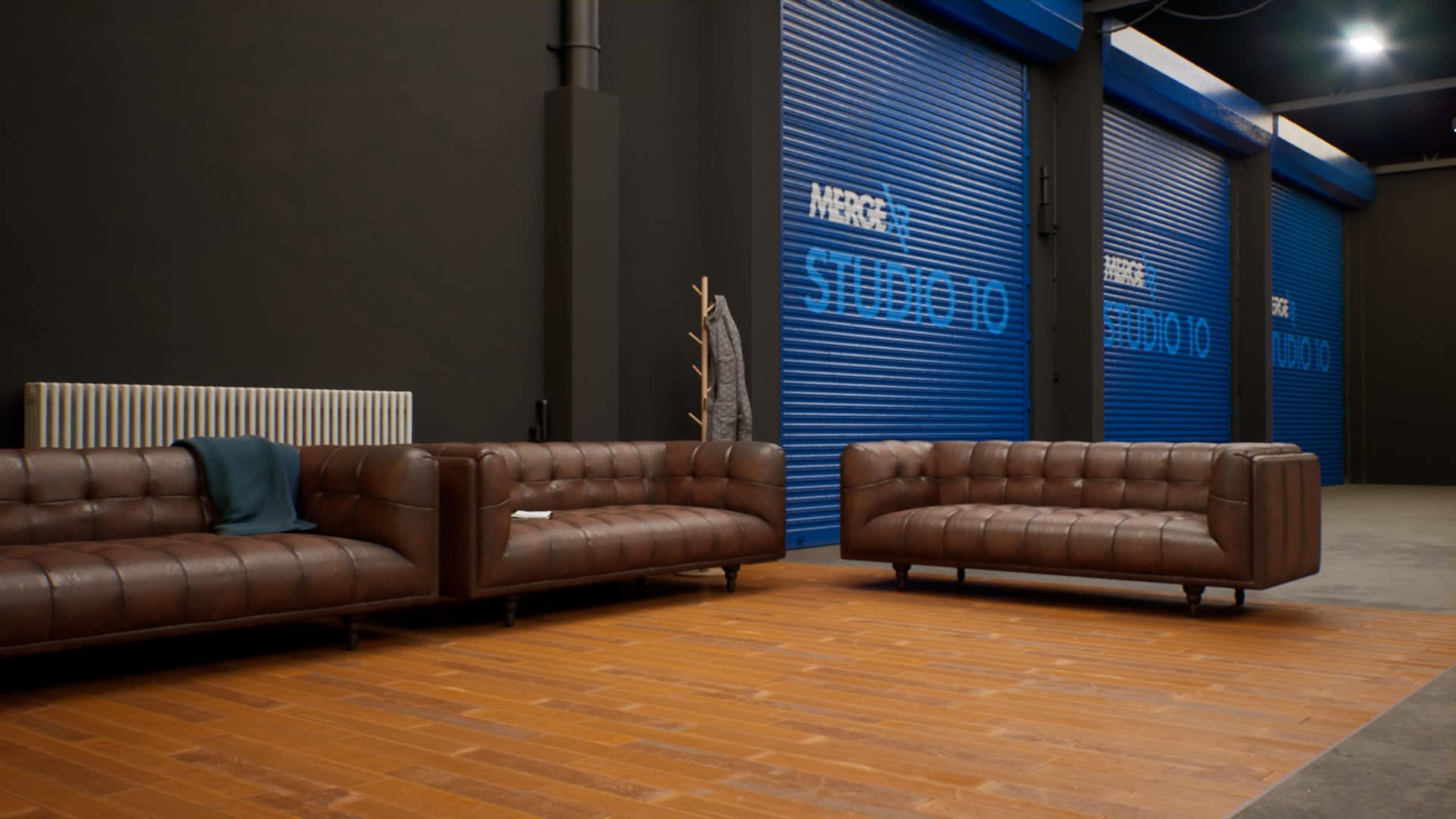 The scene features two brown leather sofas facing a blue roll-up door in a contemporary interior space with wooden flooring.