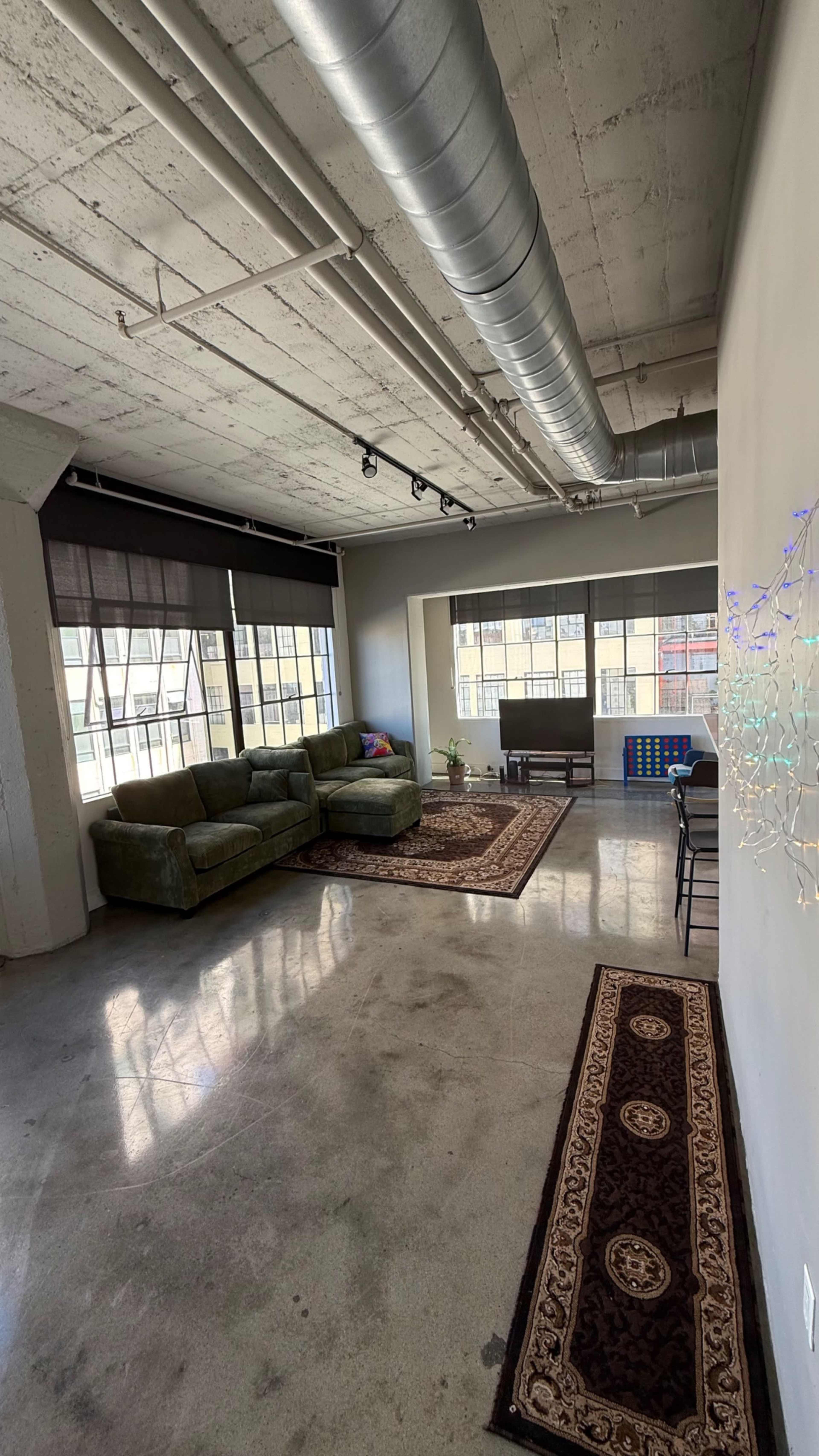 Image showcasing Downtown Studio loft space with city skyline and natural lighting., Los ...