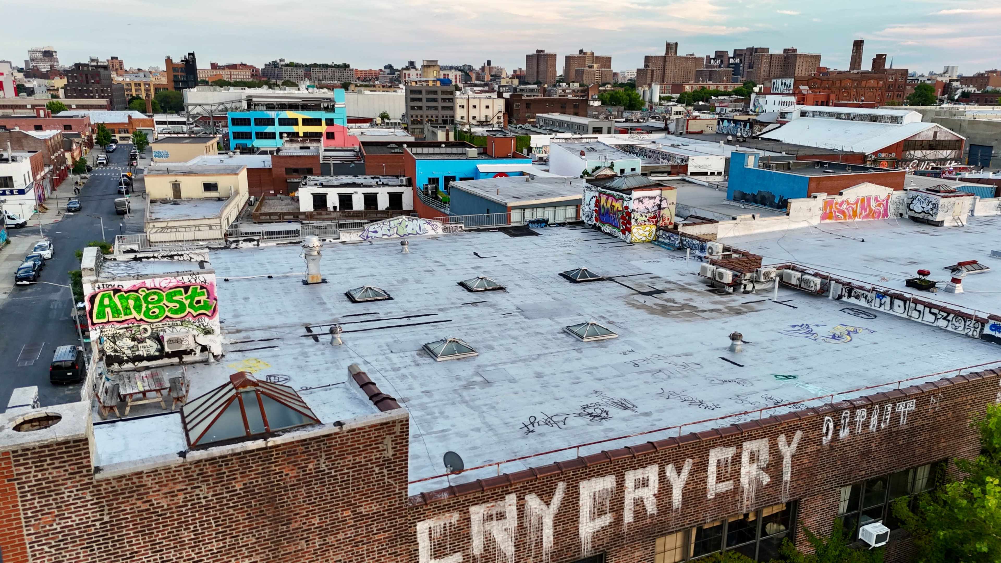 A cityscape with colorful rooftops and graffiti-covered buildings in an urban environment.