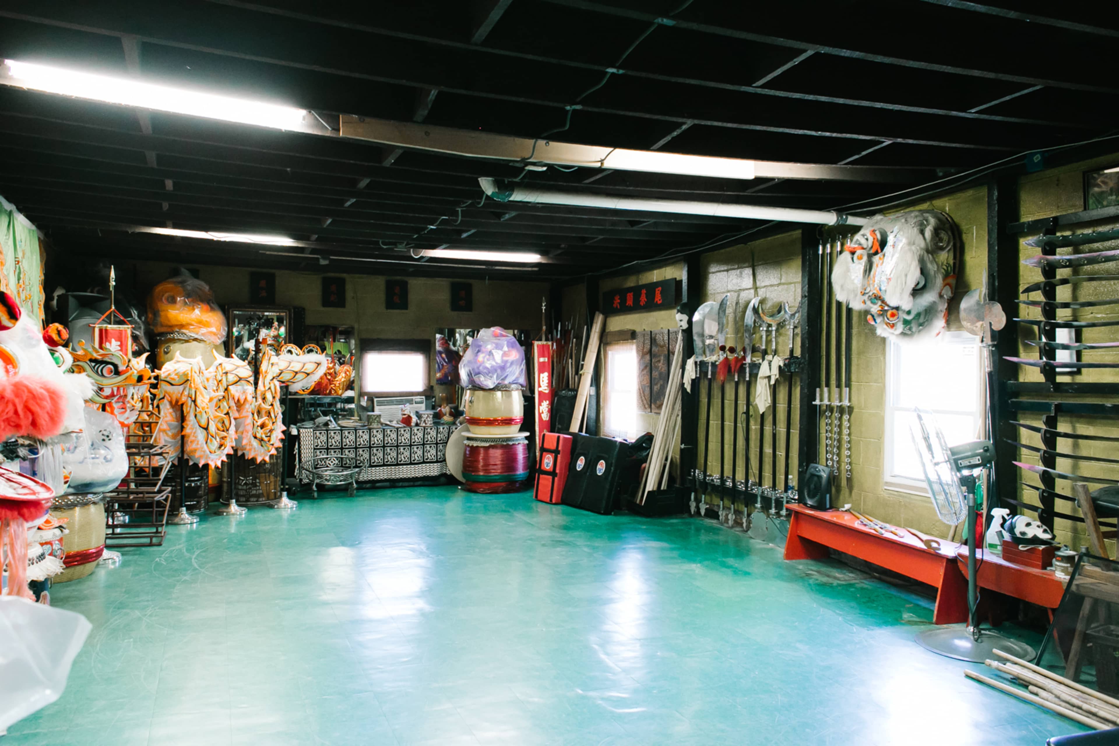 A spacious room filled with various traditional performance costumes and instruments arranged along the walls.