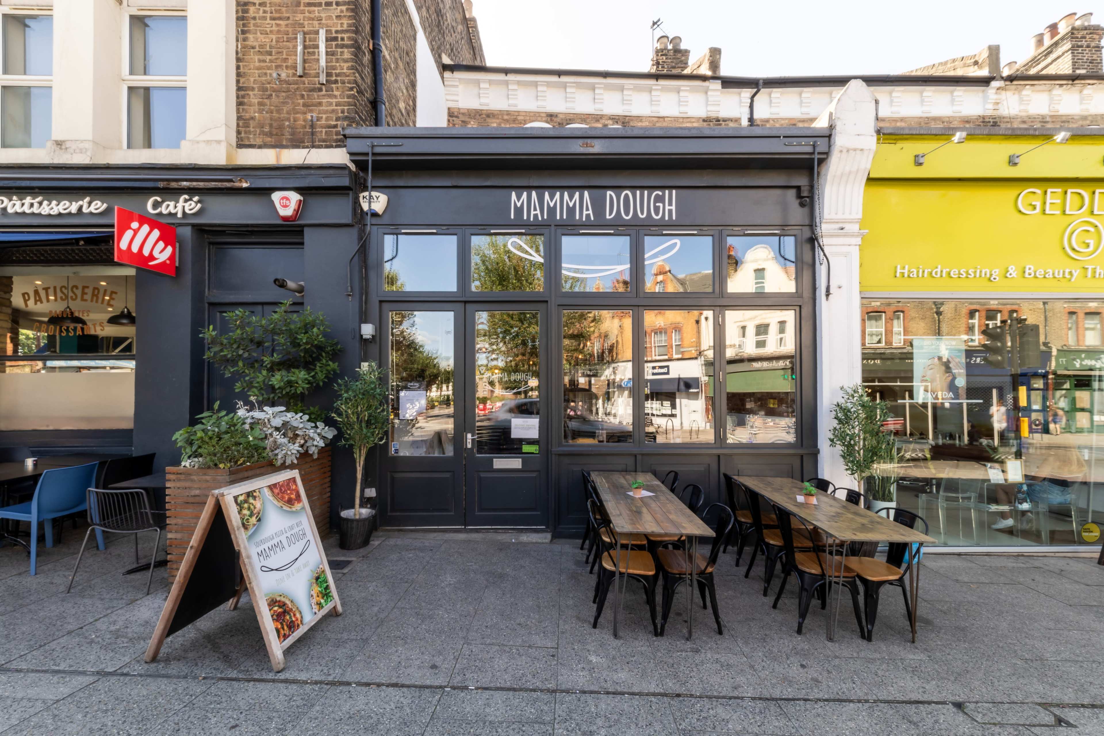 The image shows a restaurant named "Mamma Dough" with outdoor seating and a sidewalk view of neighboring shops.