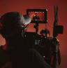 Behind the scenes video shoot on cyclorama wall and red lighting